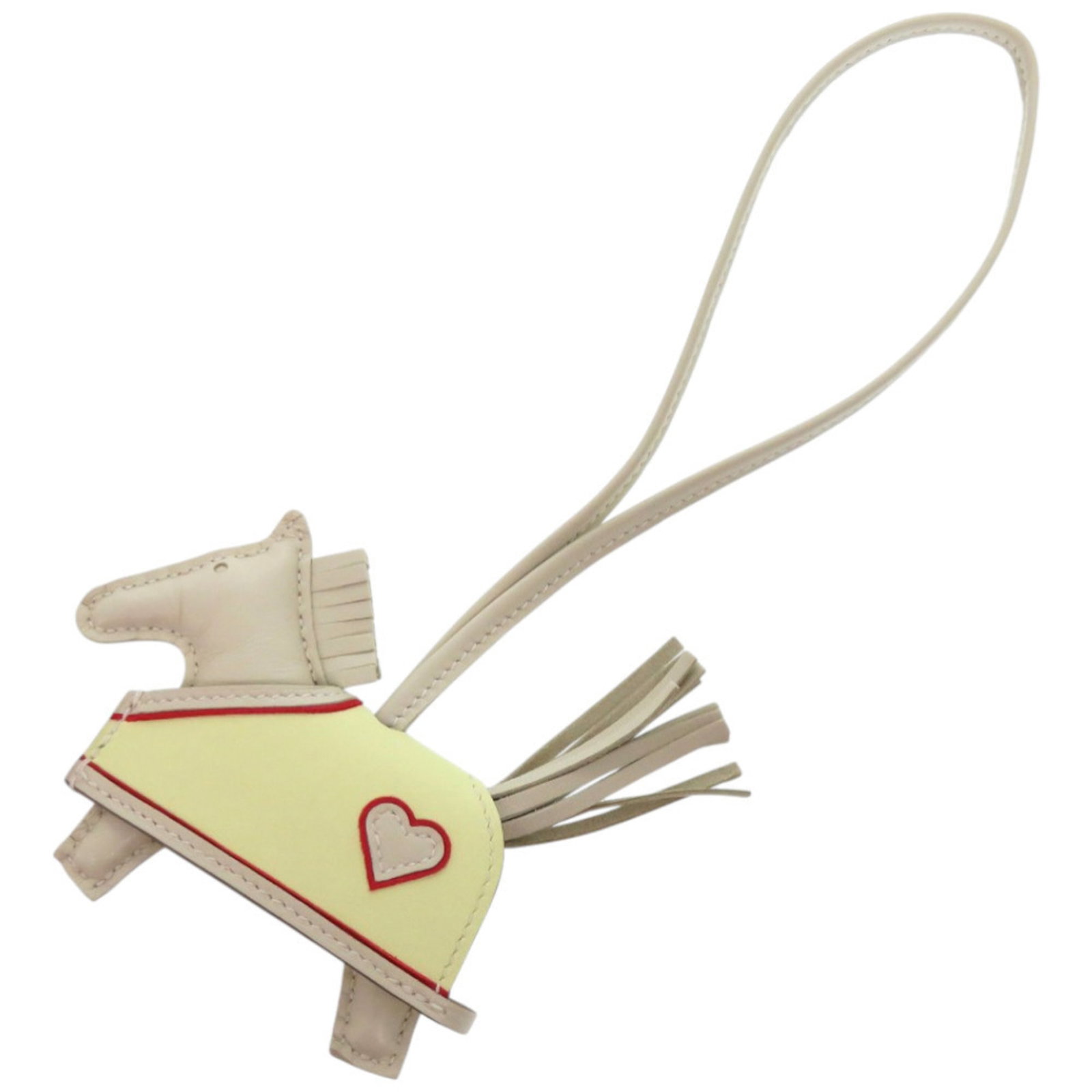 Keyring Agneau Milo Hermes: Keyring Agneau Milo Hermes Agneau Milo is a premium material used in the creation of this keyring from Hermes. Made in France, it showcases a unique white color and distinctive design. The keyring com