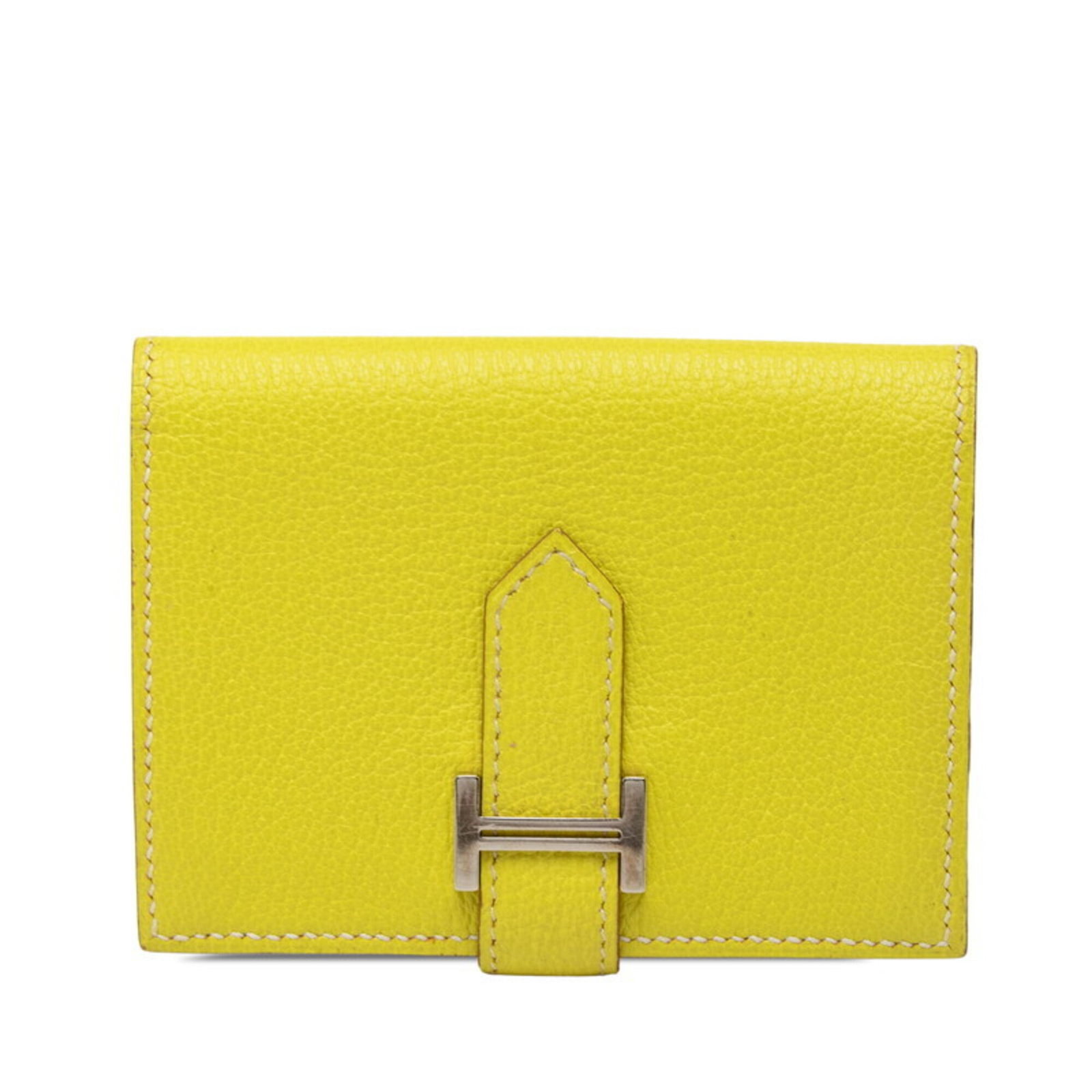 Chevre leather card case by Hermes: Chevre leather card case by Hermes Chevre leather card case by Hermes boasts a vibrant yellow hue and a sleek, compact design, measuring 7.5cm x 10cm x 1.5cm. Made from high-quality chevre leather,