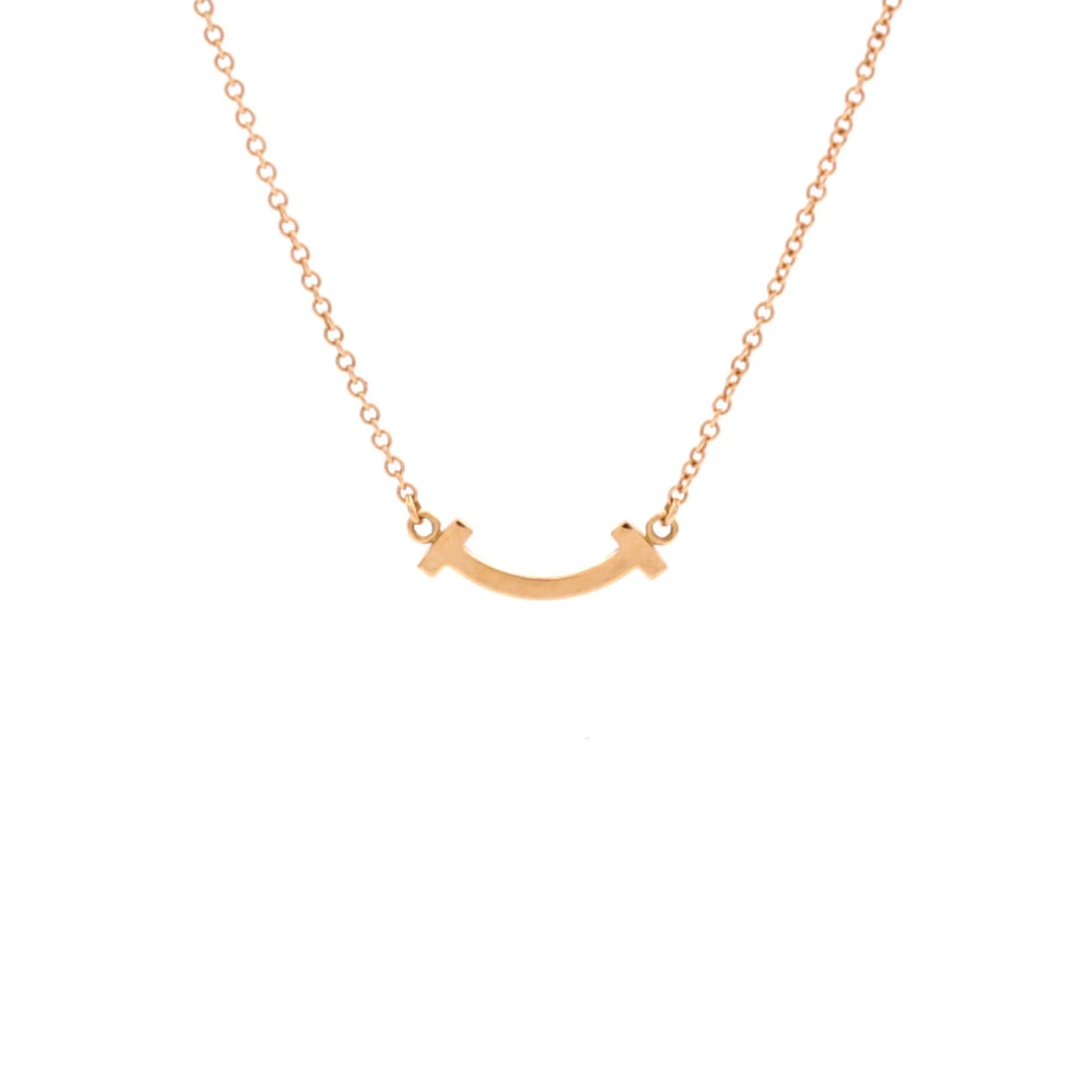 Tiffany Smile Pendant Necklace 18K Rose Gold Mini: Tiffany Smile Pendant Necklace 18K Rose Gold Mini Tiffany & Co.'s 18K Rose Gold Mini Smile Pendant Necklace is a delicate, rose gold masterpiece. This 16.0-18.0" necklace features a 4.65 mm x 14.45