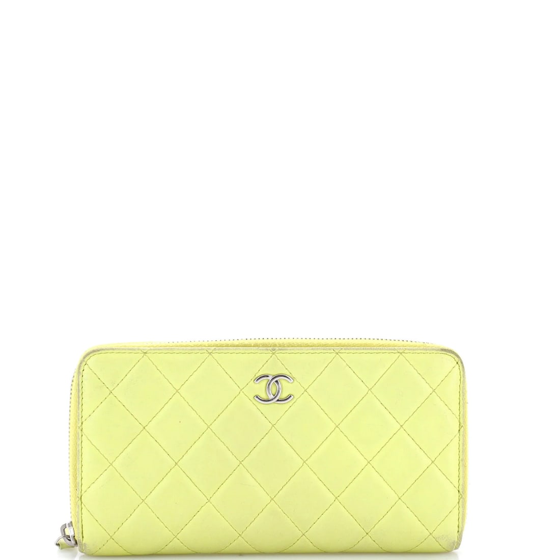 Zip around quilted lambskin wallet Chanel: Zip around quilted lambskin wallet Chanel Yellow quilted lambskin wallet with a zip around closure, measuring 4.5" in height, 8" in width, and 1" in depth, featuring a long exterior made of leather