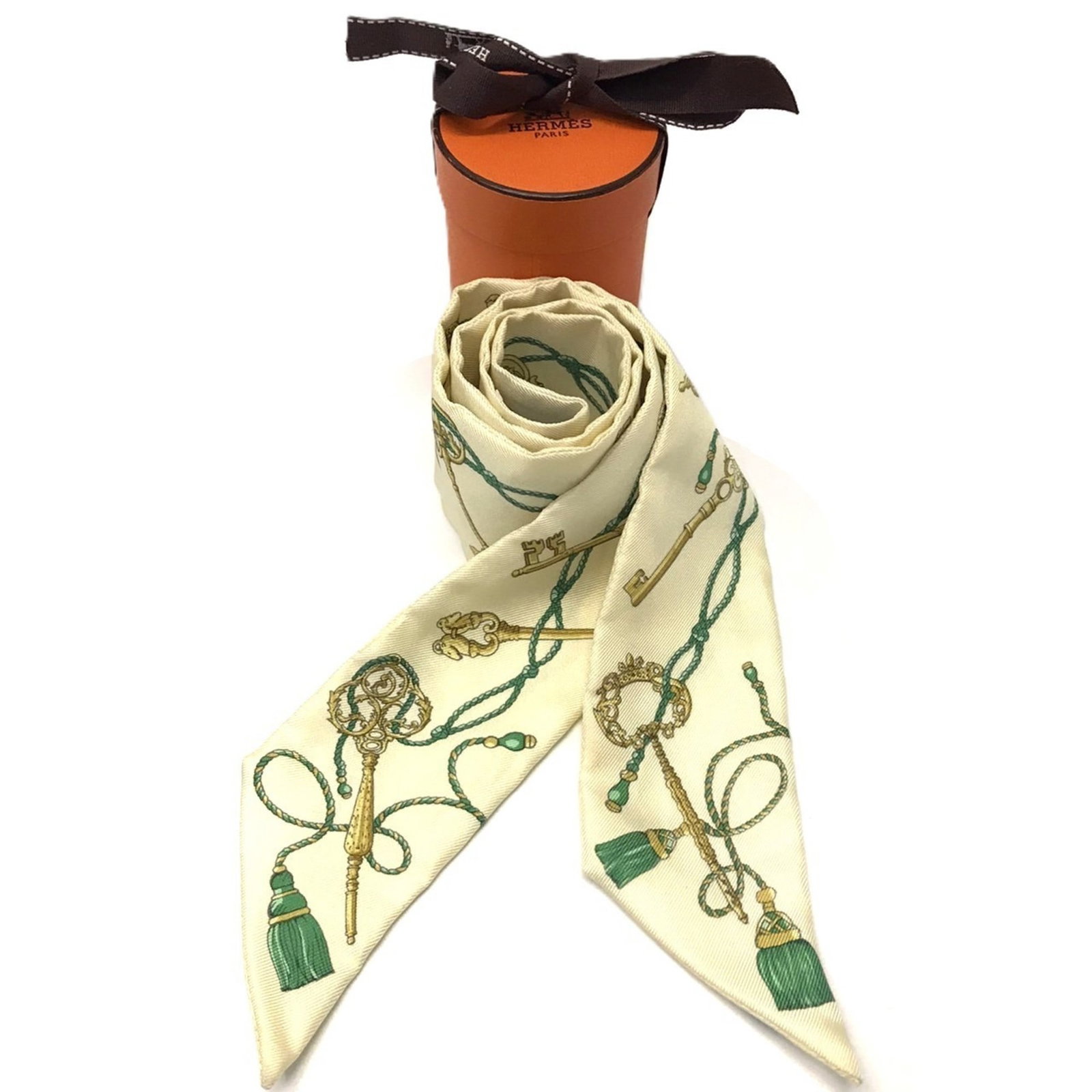 Silk Hermes Scarf: Silk Hermes Scarf Silk from Hermes, a classic Twilly scarf in a vibrant yellow hue, features a compact 5cm width and 84.5cm length. Made from high-quality silk, this scarf is a stylish accessory for a