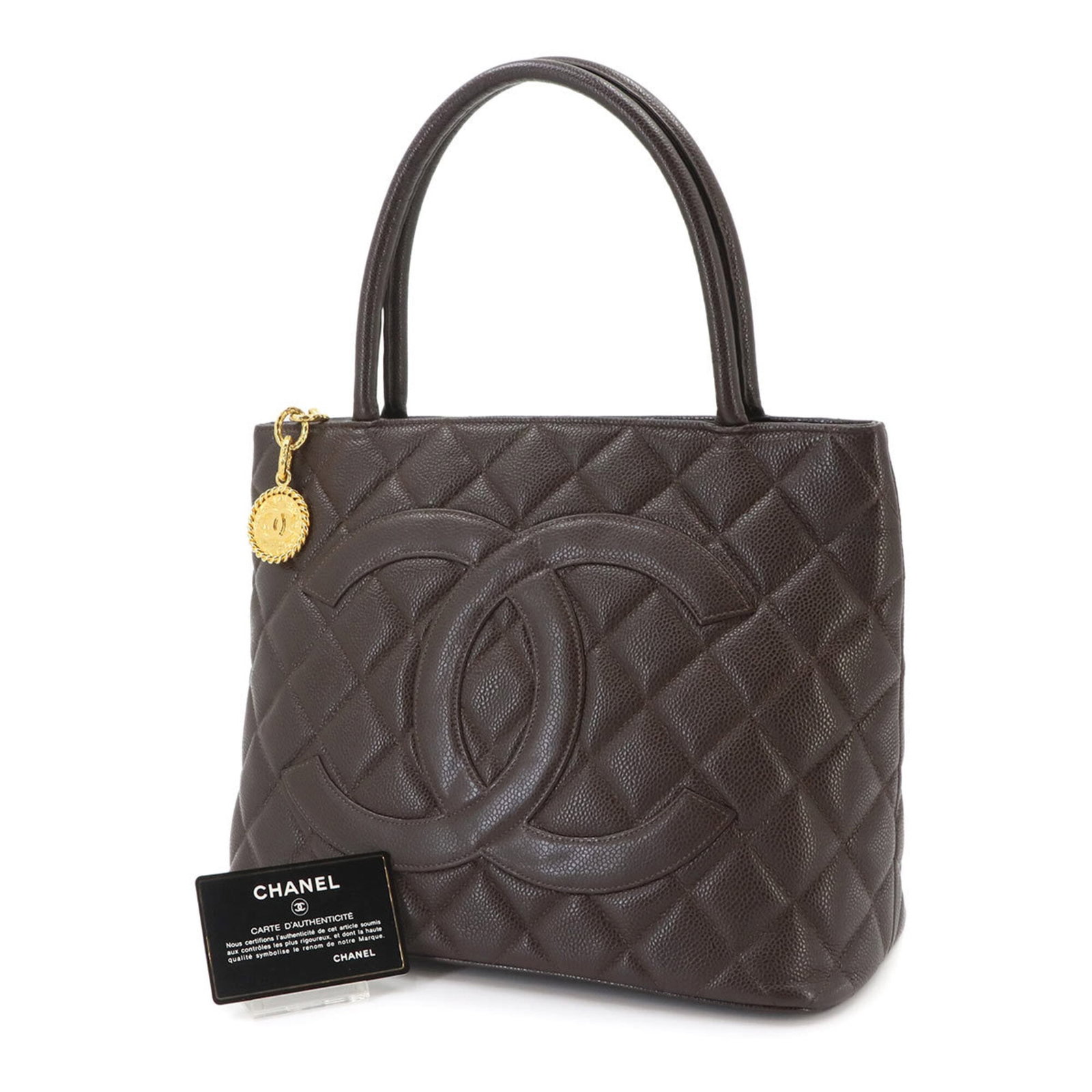 Calfskin Grained Chanel Tote Bag: Calfskin Grained Chanel Tote Bag Calfskin Grained Chanel Tote Bag, crafted from high-quality Grained Calfskin, features a classic design with a Dark brown color. Measuring 24.5cm x 30cm x 15cm, this