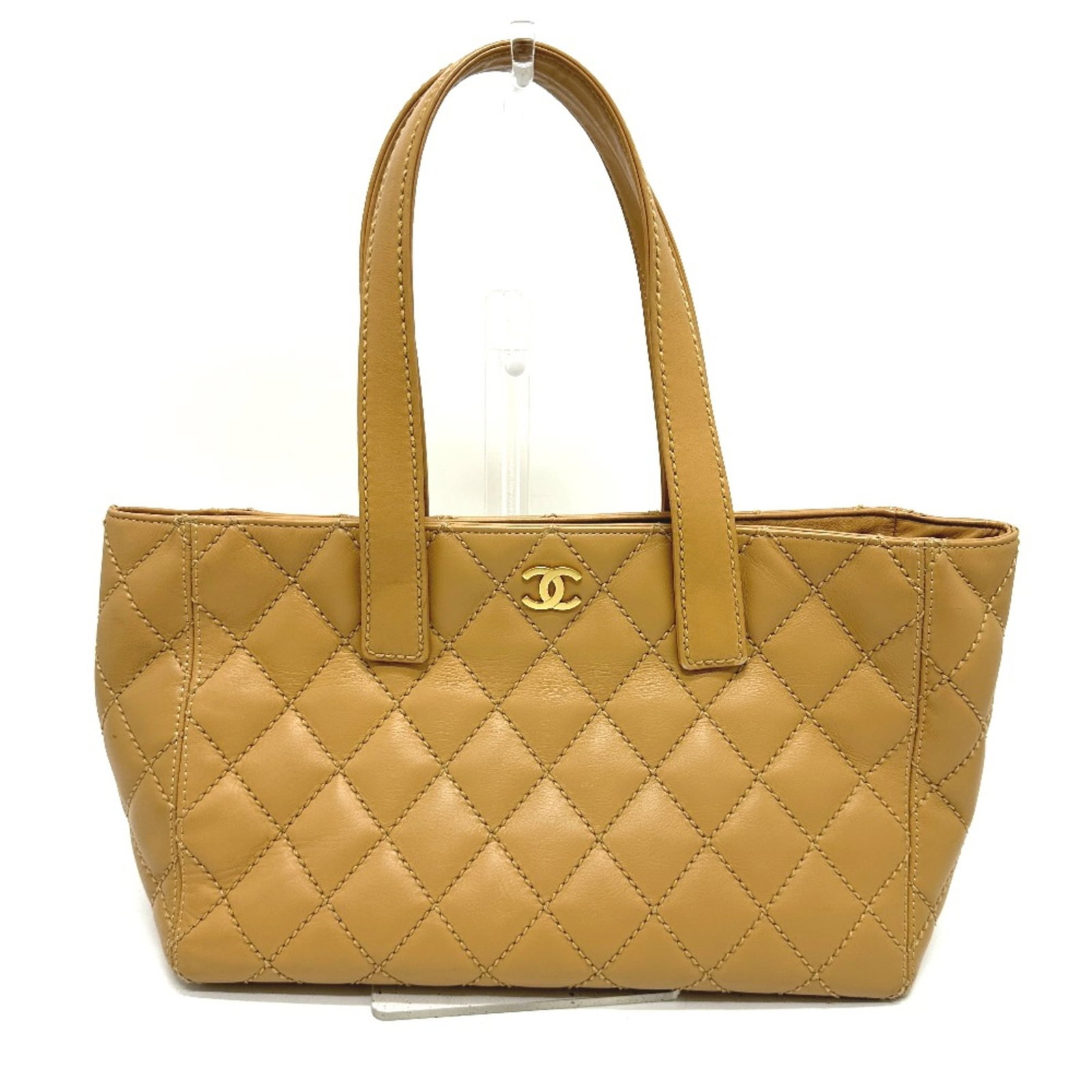 Leather Chanel Tote Bag: Leather Chanel Tote Bag Beige leather tote bag from Chanel, measuring 35cm wide, 24cm tall, and 13.5cm deep, with a 24-inch long handle. The bag features a 10.4 x 6.7-inch pouch and is marked with a