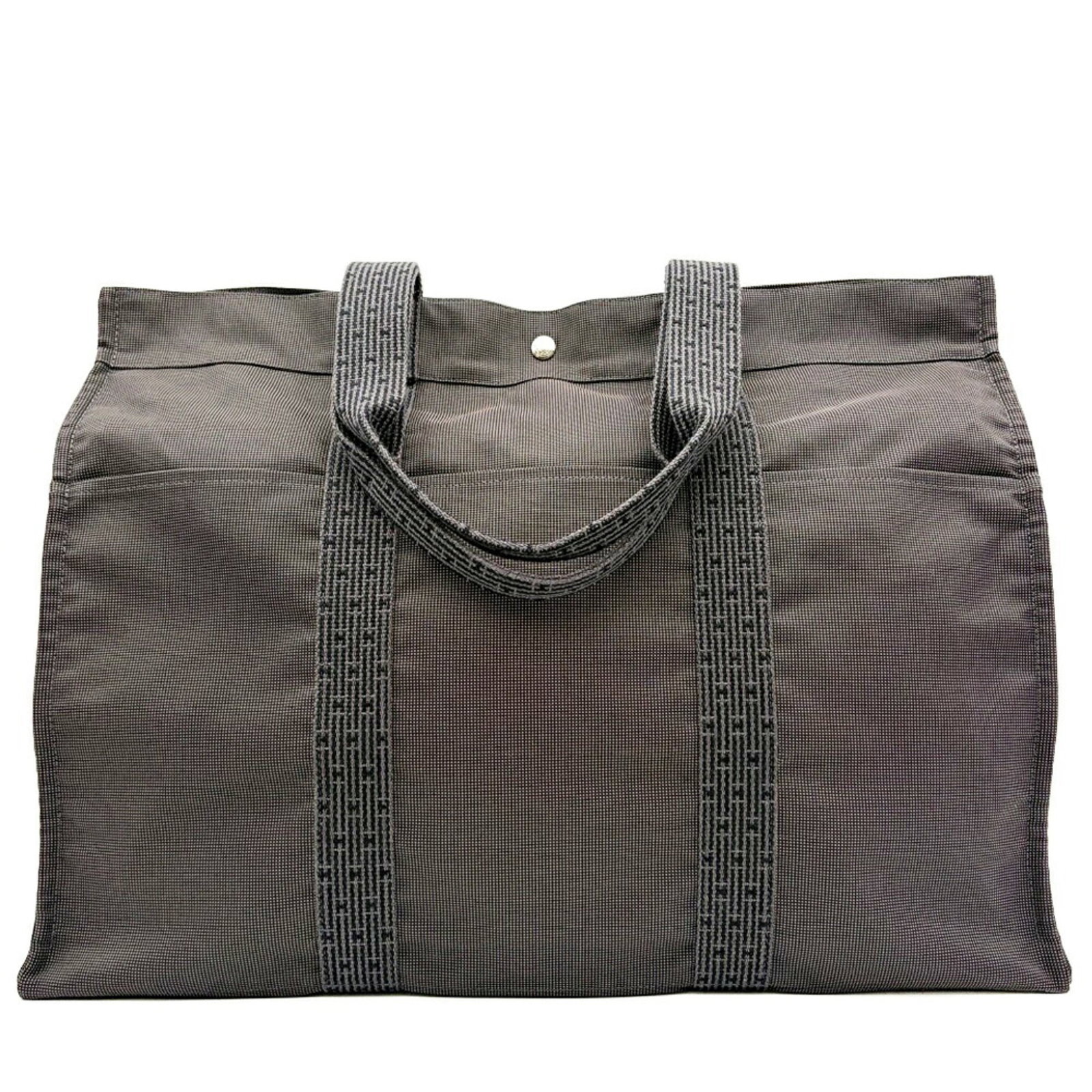 Canvas tote bag Hermes: Canvas tote bag Hermes Canvas tote bag from Hermes, made of high-quality canvas in a versatile gray color, measuring 44cm x 56.5cm x 26cm. The bag's classic design and durable construction make it a