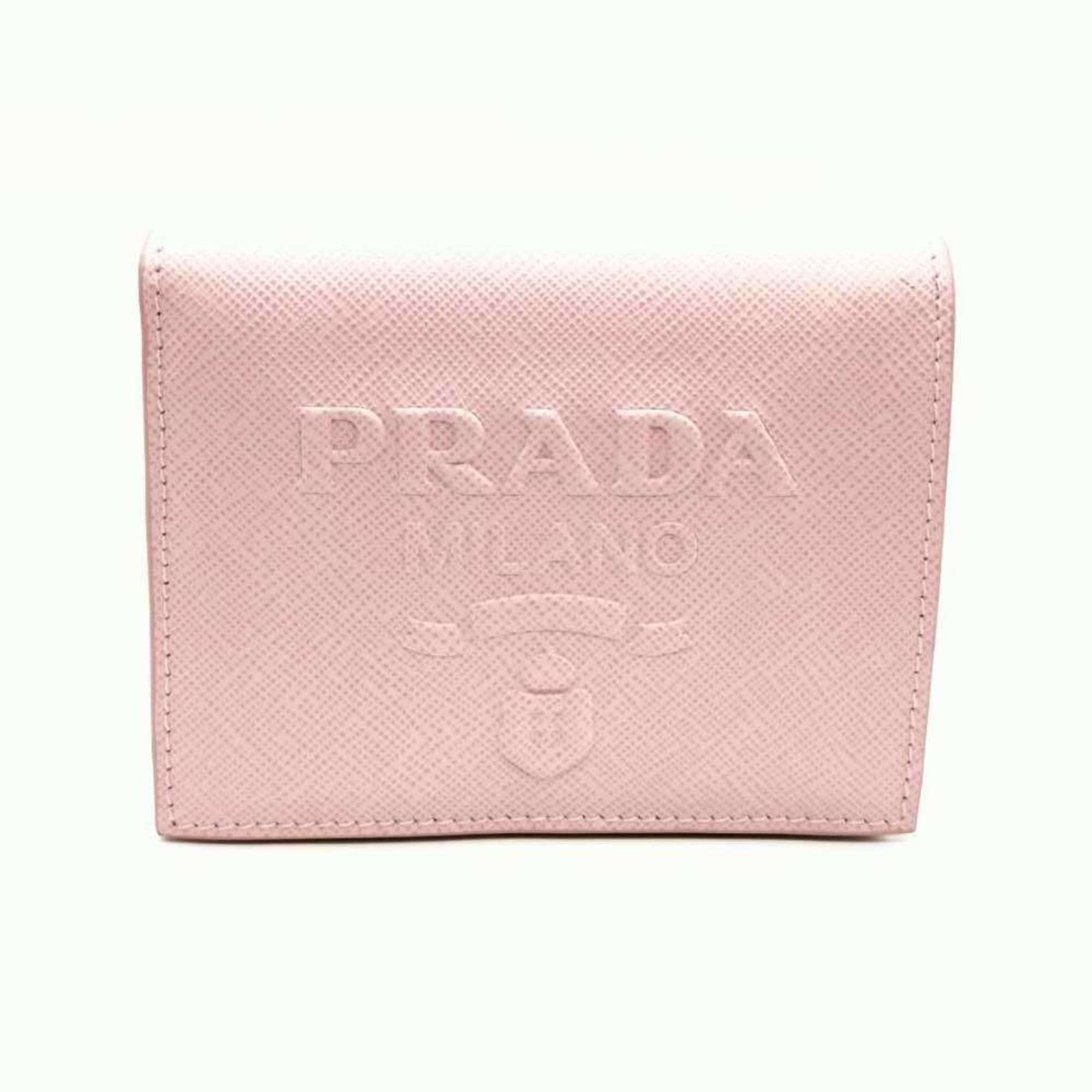 Prada Wallet (Bi-Fold) Embossed: Prada Wallet (Bi-Fold) Embossed Prada's bi-fold wallet features an embossed design, showcasing the brand's signature style. Made from high-quality materials, this pink wallet measures 9cm x 11cm x 2cm