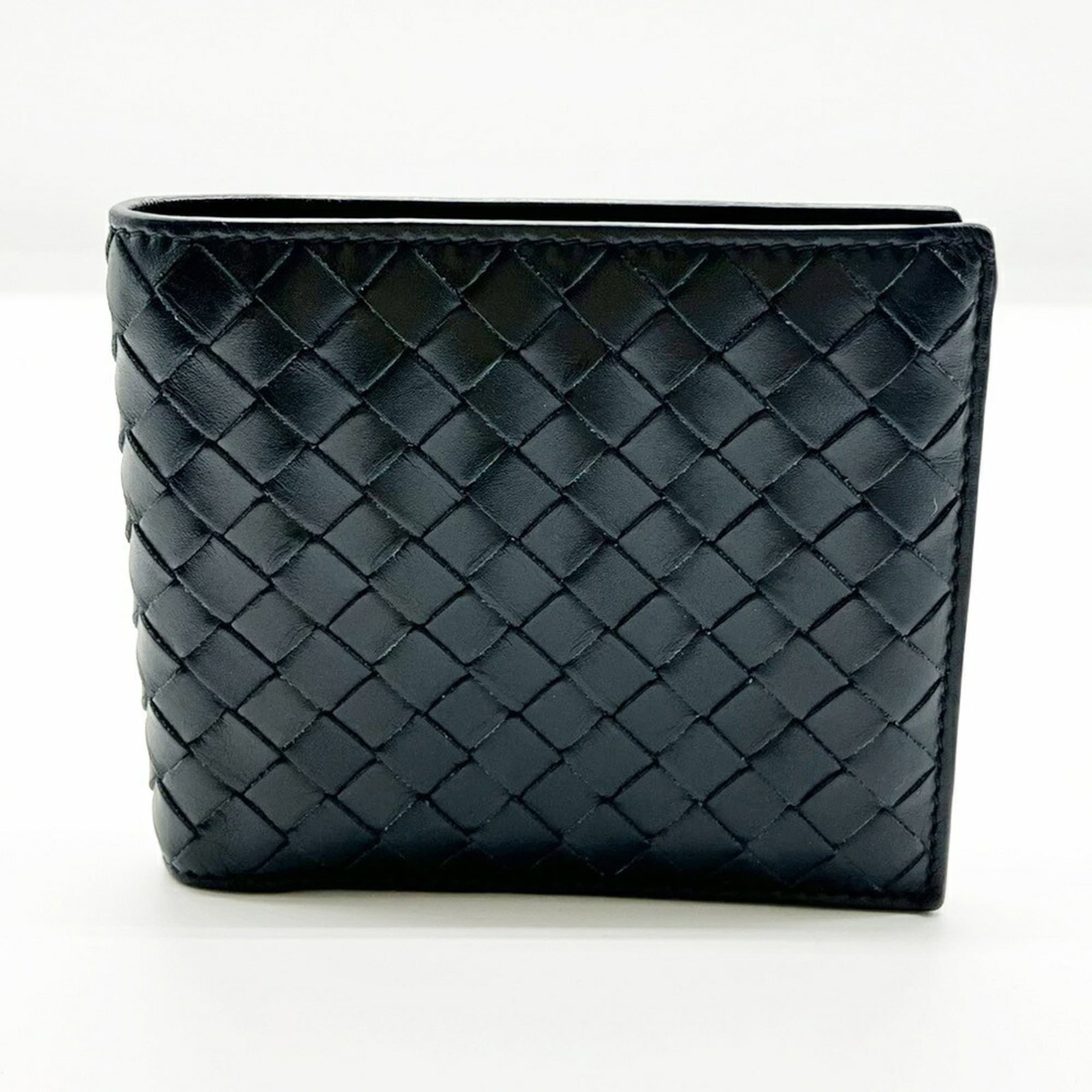 Bottega Veneta Wallet (Bi-Fold) Leather: Bottega Veneta Wallet (Bi-Fold) Leather Navy leather bi-fold wallet from Bottega Veneta, measuring 9.5cm x 11cm x 2cm. This classic wallet features a simple yet elegant design, with a durable leather