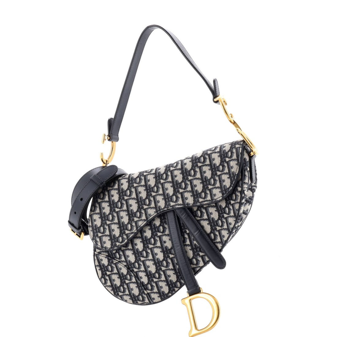 Saddle Handbag Strap Oblique Canvas Medium Christian Dior: Saddle Handbag Strap Oblique Canvas Medium Christian Dior Saddle Handbag with Strap Oblique Canvas Medium from Christian Dior features a striking blue canvas exterior with oblique design,