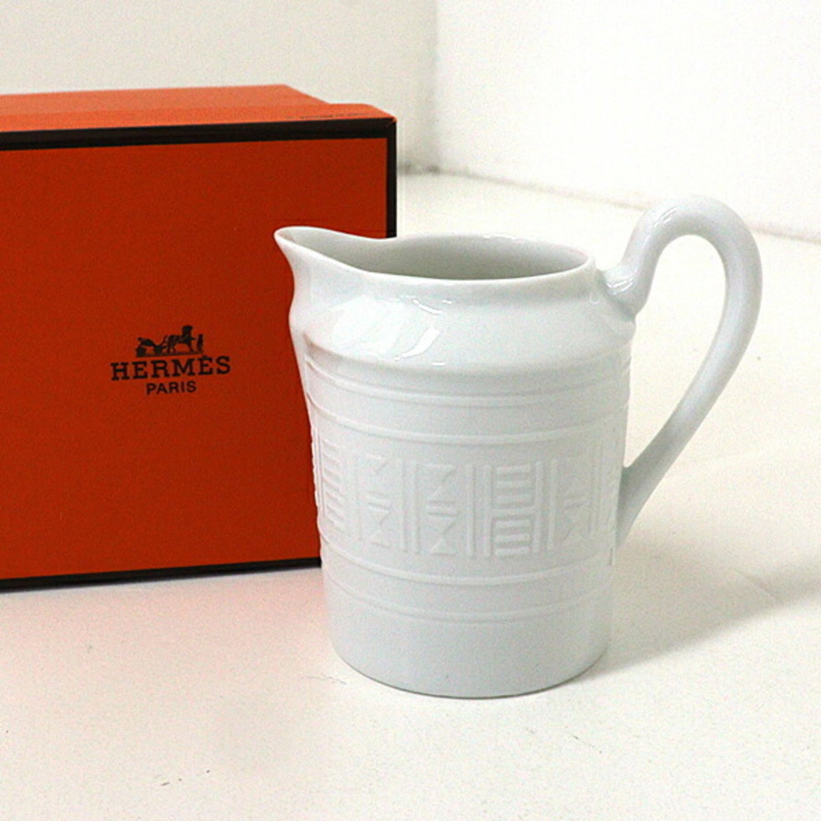 Hermes Coffee Cup: Hermes Coffee Cup White pottery coffee cup from Hermes, standing 9cm tall. This cup showcases the brand's signature style and craftsmanship. Its simple yet elegant design makes it a beautiful addition