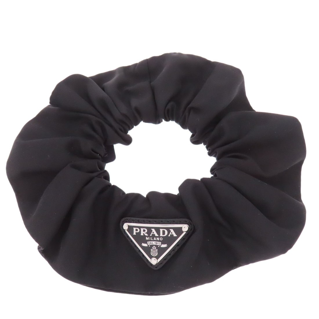 Nylon Logohardware Scrunchie Accessory Hair Prada: Nylon Logohardware Scrunchie Accessory Hair Prada Nylon Logohardware Scrunchie Accessory Hair Prada is made from nylon and features a black exterior color. The item bears a signature, but its authenti