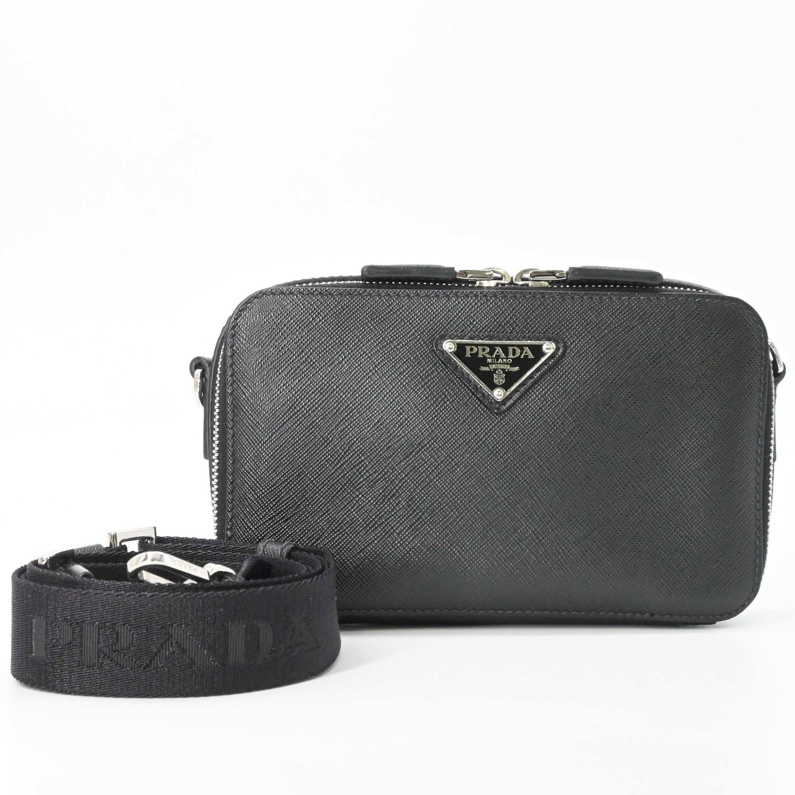 Saffiano Triangle Prada Bag Shoulder: Saffiano Triangle Prada Bag Shoulder Saffiano triangle Prada bag shoulder in black, made from high-quality Saffiano material, features a sleek and modern design. The bag measures 11cm x 18.5cm x 4cm,
