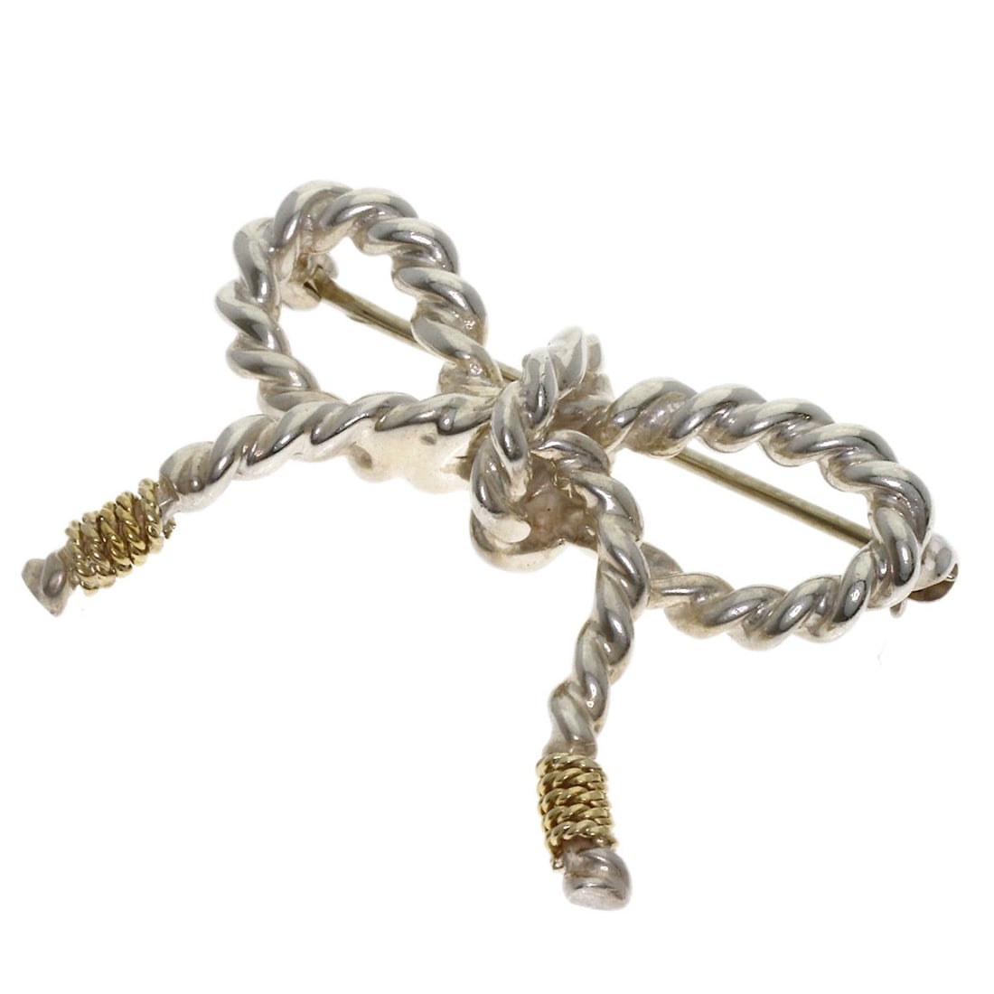 Silver 18K Yellow Gold Twist Ribbon Brooch Tiffany&Co: Silver 18K Yellow Gold Twist Ribbon Brooch Tiffany&Co Silver 18K Yellow Gold Twist Ribbon Brooch Tiffany&CoThis 18K yellow gold brooch features a twist ribbon design in silver, showcasing the