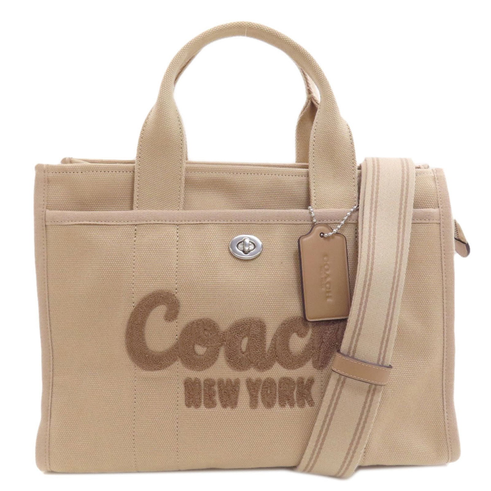 Canvas tote bag by Coach: Canvas tote bag by Coach Canvas tote bag by Coach, featuring a classic beige color and sturdy canvas material, with a convenient zipper closure and adjustable strap length. The bag measures 26cm x