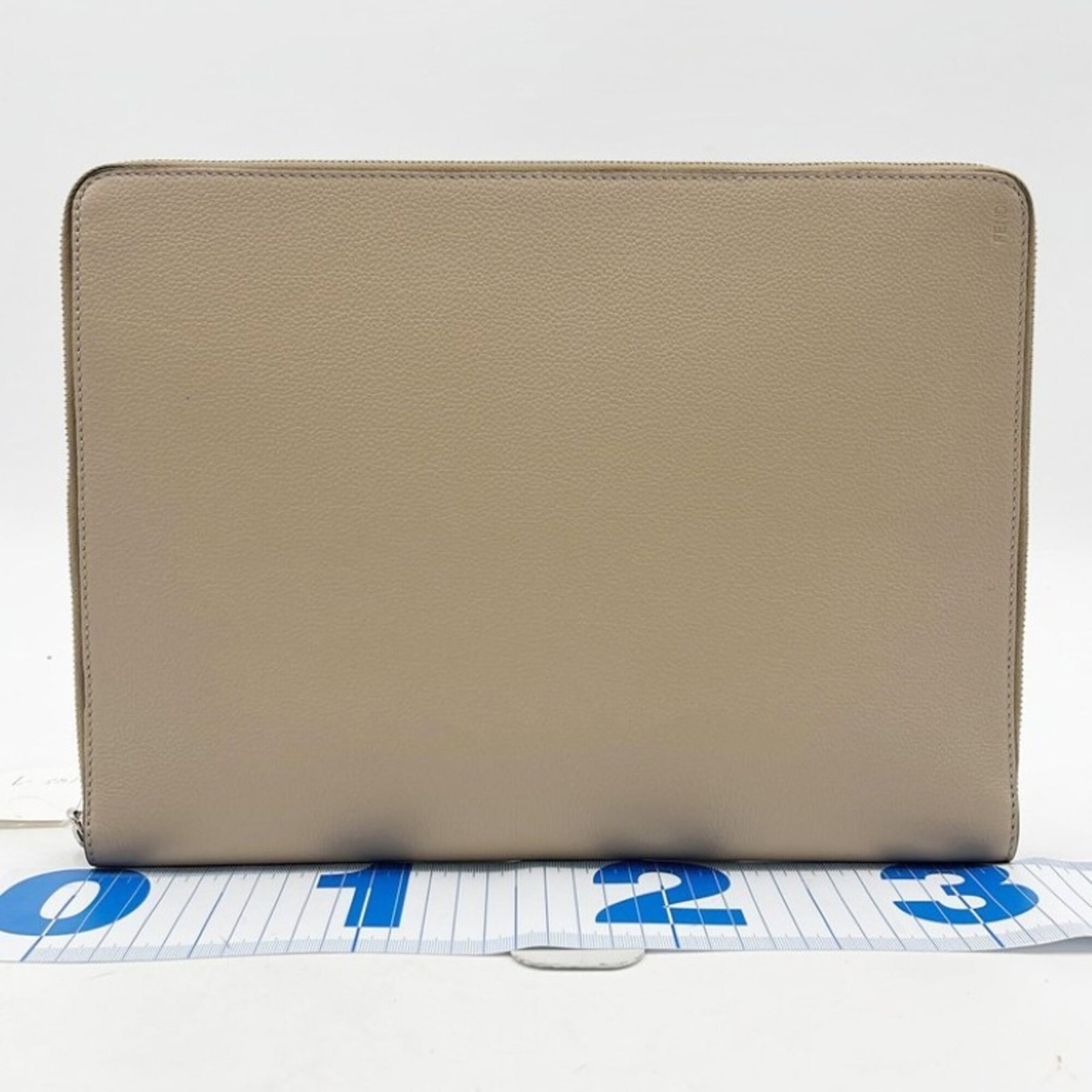 Fendi Bag Leather Clutch: Fendi Bag Leather Clutch The Fendi Bag Leather Clutch is a timeless piece, boasting a classic beige leather design. Measuring 25cm x 34cm x 3cm, this clutch bag is a versatile accessory that can be ea