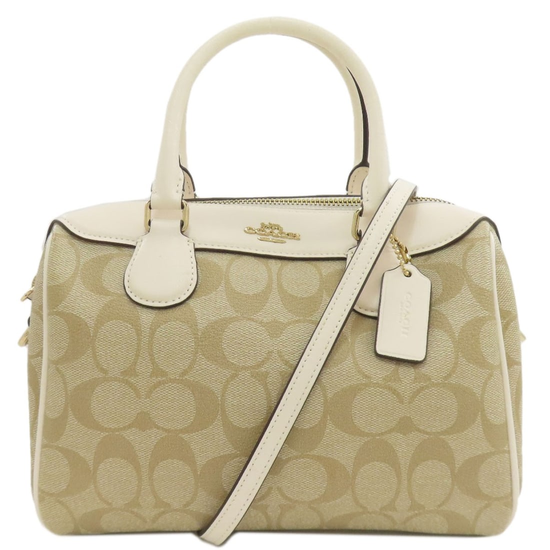 Signature 2Way Handbag Coach F32203: Signature 2Way Handbag Coach F32203 The Coach F32203 2Way Handbag boasts a sleek, beige design with a durable PVC exterior. Its signature 2Way design allows for a versatile and convenient carry style,