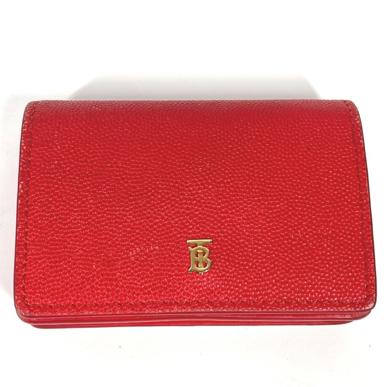 Bi Fold Leather Wallet: Bi Fold Leather Wallet The bi-fold leather wallet features a bold red color and measures 7cm x 10cm. Made from high-quality leather, this wallet boasts a classic design with a simple yet elegant