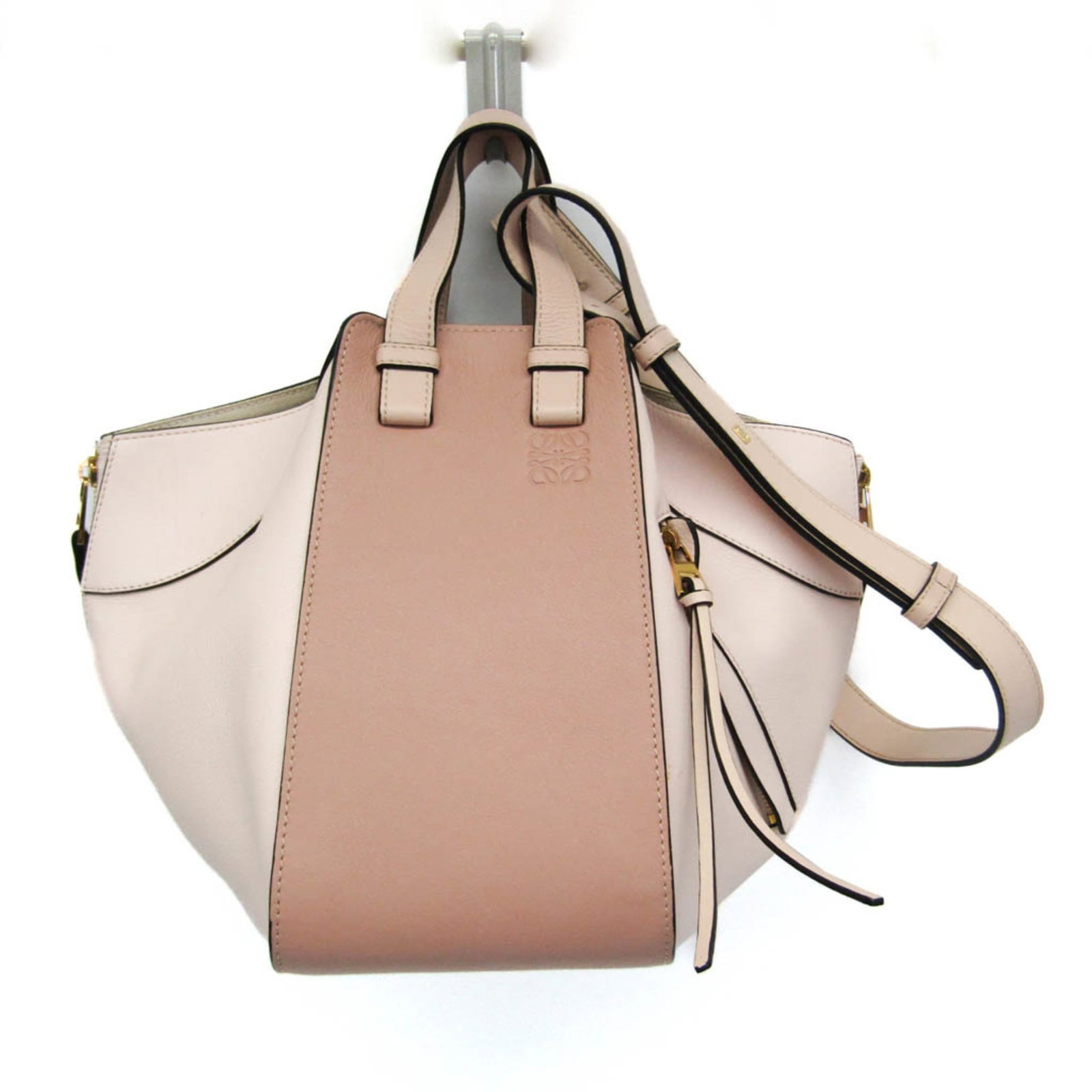 Shoulder Bag Leather Loewe Handbag: Shoulder Bag Leather Loewe Handbag Small, stylish shoulder bag from Loewe's Hammock line, crafted from high-quality leather in a light pink, pink beige hue. The bag features an open pocket and a
