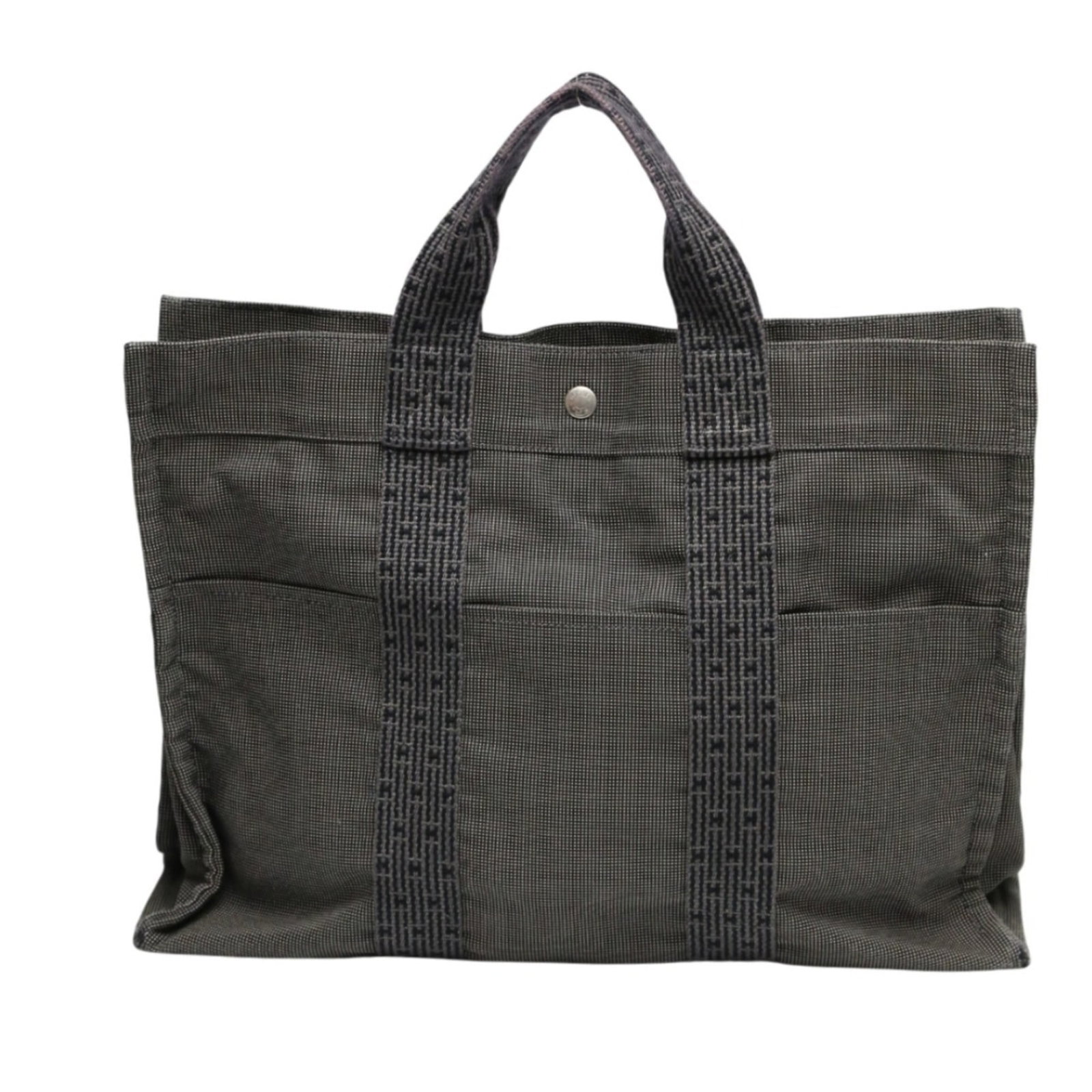 Canvas tote bag Hermes: Canvas tote bag Hermes Canvas tote bag from the iconic Hermes Line, crafted from high-quality canvas in a versatile gray hue. The bag features a sturdy zipper closure and a comfortable handle drop,