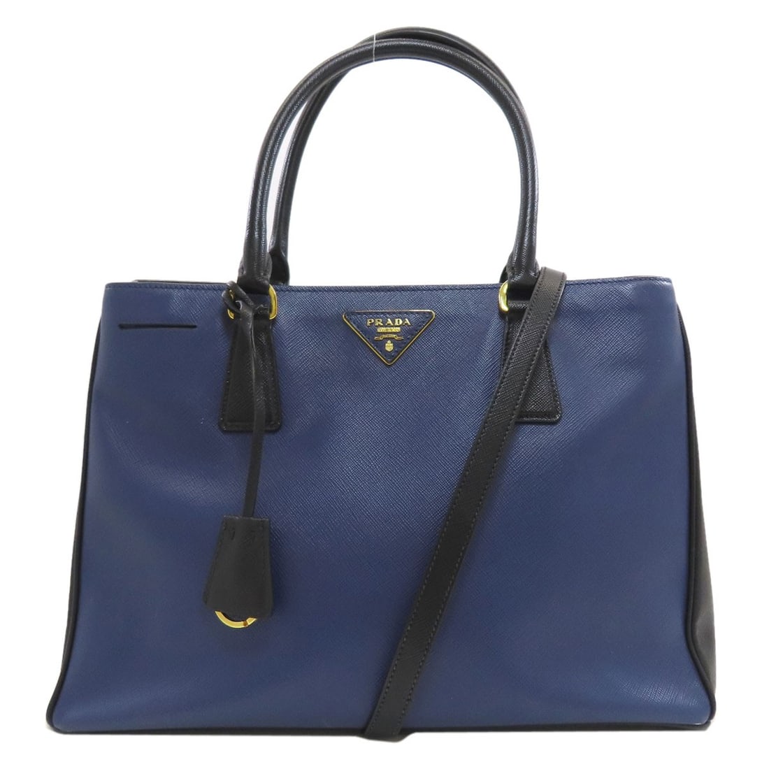 Safiano Prada Tote Bag 2way Triangle: Safiano Prada Tote Bag 2way Triangle Safiano Prada Tote Bag 2way Triangle is a stylish blue tote bag with a unique 2way triangle design. Measuring 8.7 inches in height and 5.9 inches in depth, this ba