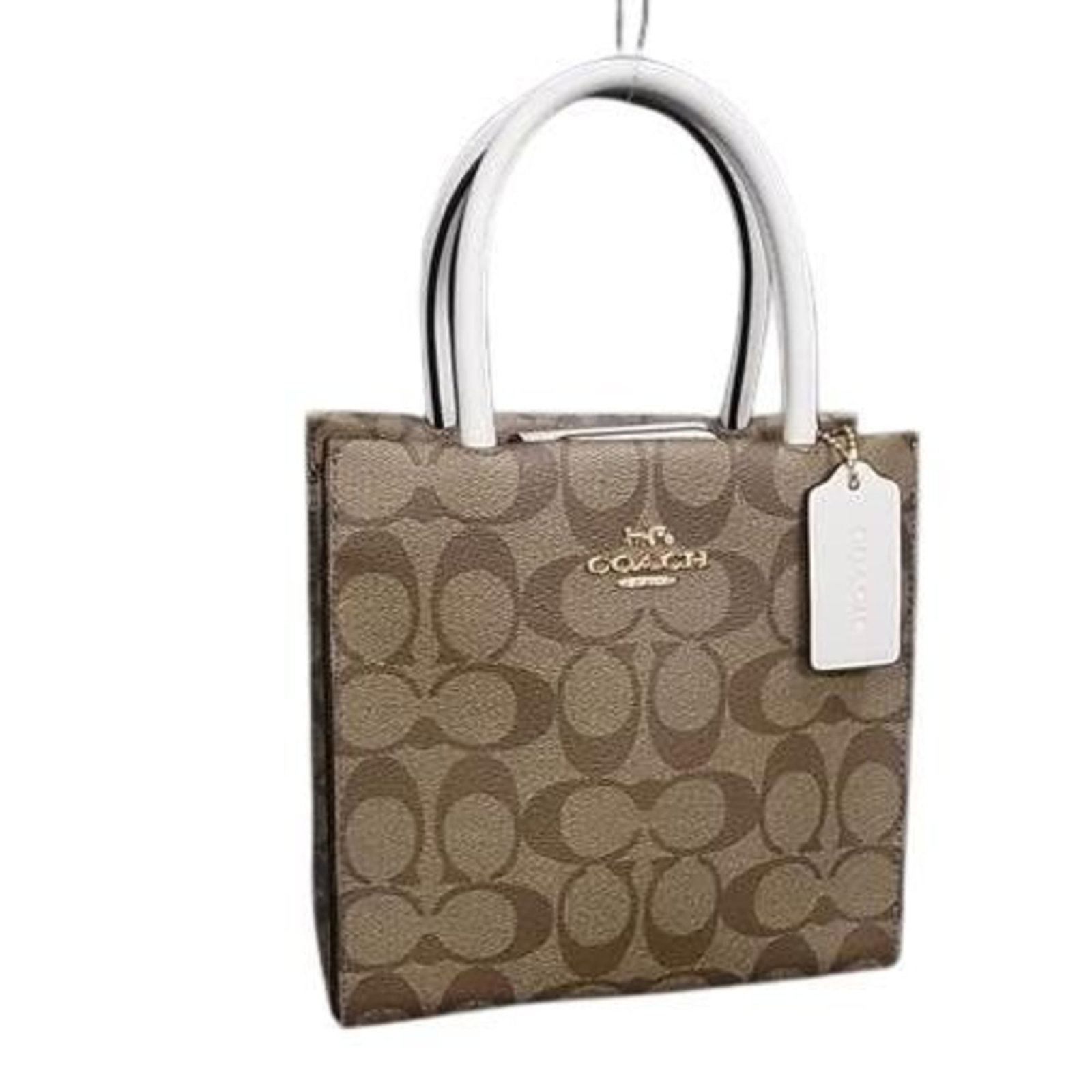 Shoulder Bag Pvc Tote Handbag Coach: Shoulder Bag Pvc Tote Handbag Coach This Coach Signature handbag is made from durable PVC material and features a classic brown color. Measuring 17cm x 17cm x 6.5cm, it's a compact and stylish