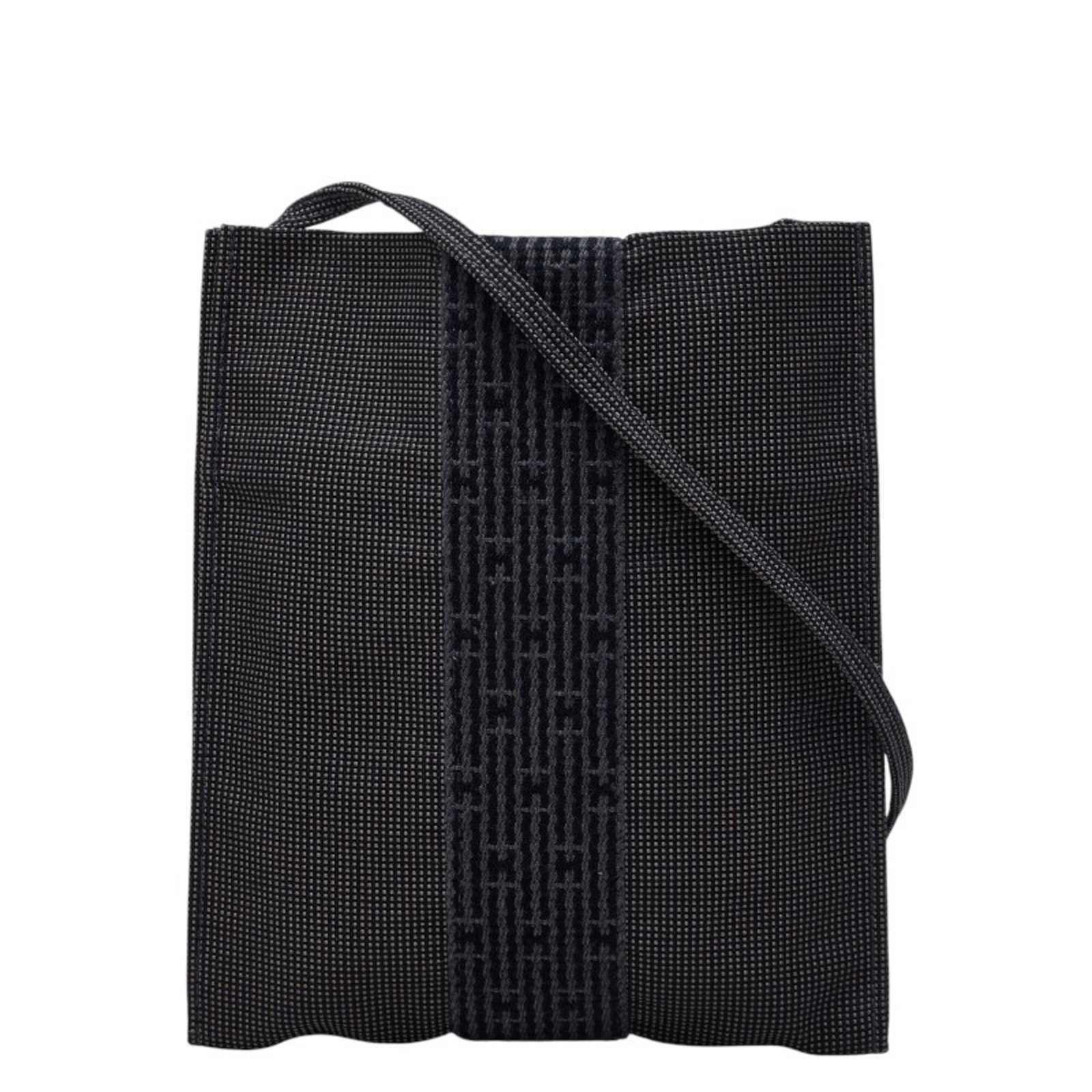 Shoulder Bag Canvas By Hermes: Shoulder Bag Canvas By Hermes Canvas by Hermes shoulder bag in a versatile gray color, featuring an open closure and adjustable straps that drop to 57.5cm. This pochette-style bag measures 19.5cm x