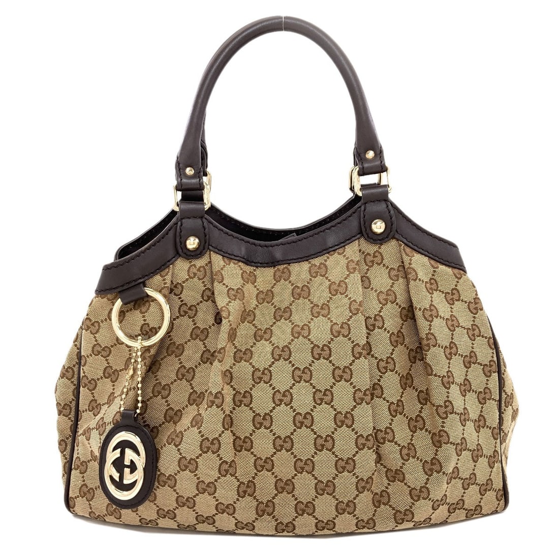 Sukey Gg Handbag Canvas Gucci: Sukey Gg Handbag Canvas Gucci Sukey Gg Handbag Canvas Gucci is a brown canvas handbag with a magnetic closure, measuring 11.8 inches in height and 4.7 inches in depth. The bag's exterior is made of
