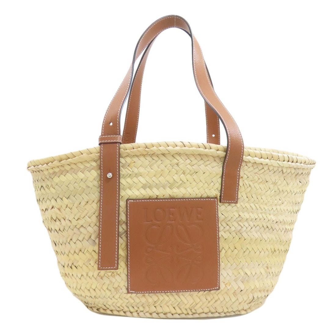 Loewe Basket Bag Tote Bag Raffia: Loewe Basket Bag Tote Bag Raffia Beige Raffia Tote Bag from LOEWE. This tote bag features a natural beige exterior made from raffia, a classic and stylish material. The simple yet elegant design