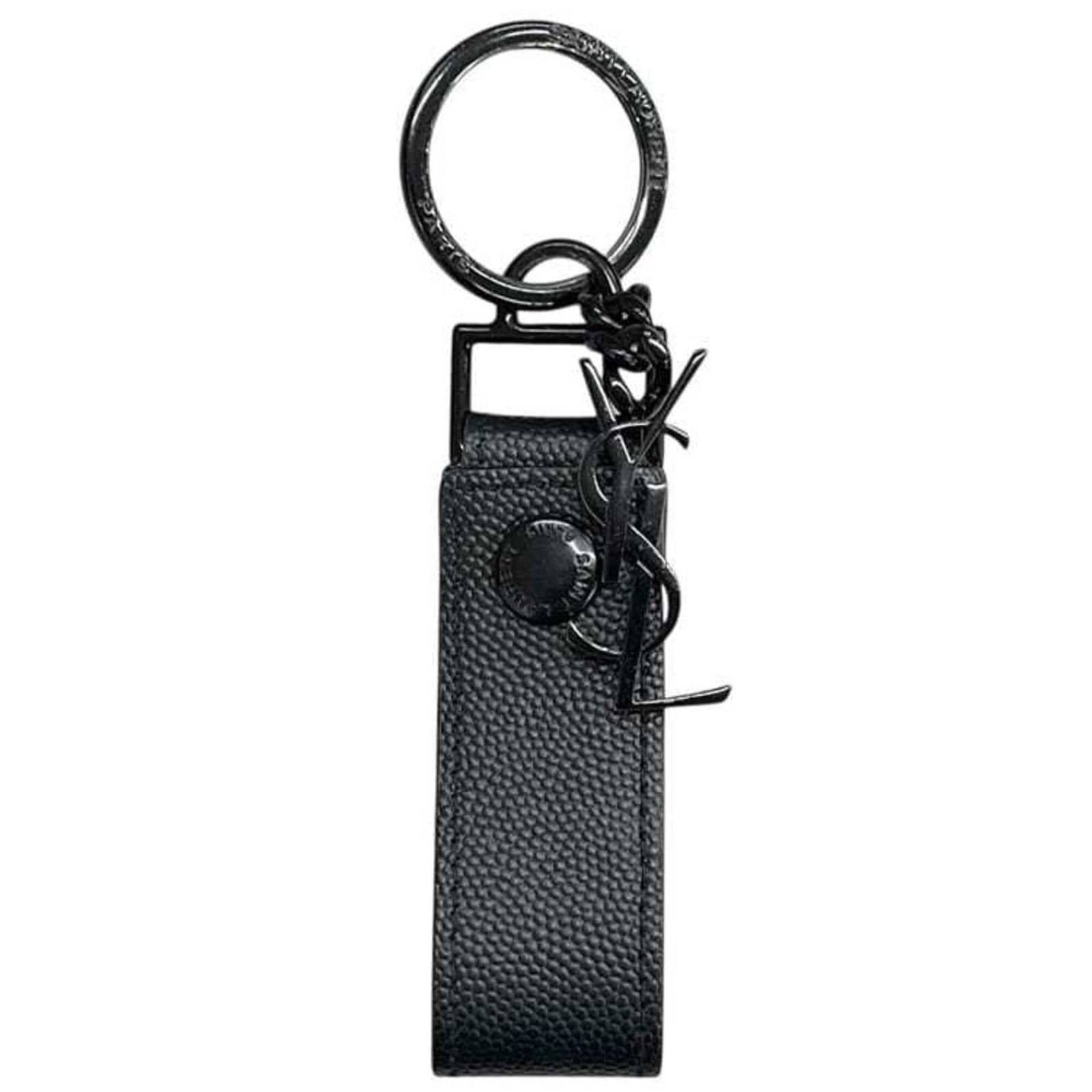 Saint Laurent Keyring Leather Metal: Saint Laurent Keyring Leather Metal The Saint Laurent Keyring Leather Metal is a sleek and sophisticated accessory, featuring a durable black leather exterior and a metallic accent that adds a touch o