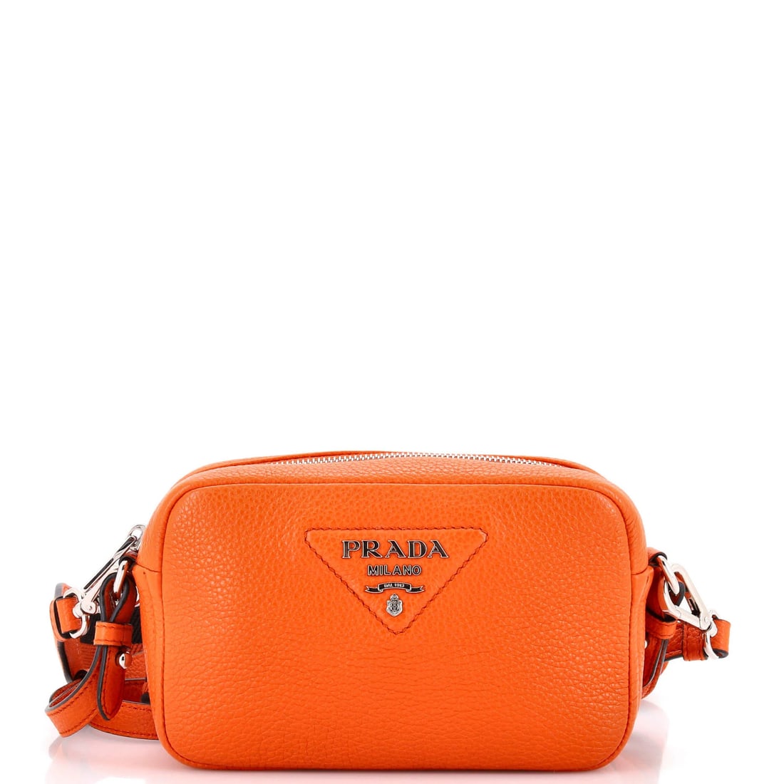 Vitello Flou Daino Crossbody Camera Small Prada: Vitello Flou Daino Crossbody Camera Small Prada Vitello Flou Daino Small Prada crossbody camera bag is a vibrant orange leather accessory with a small size and adjustable strap. The bag features a fab