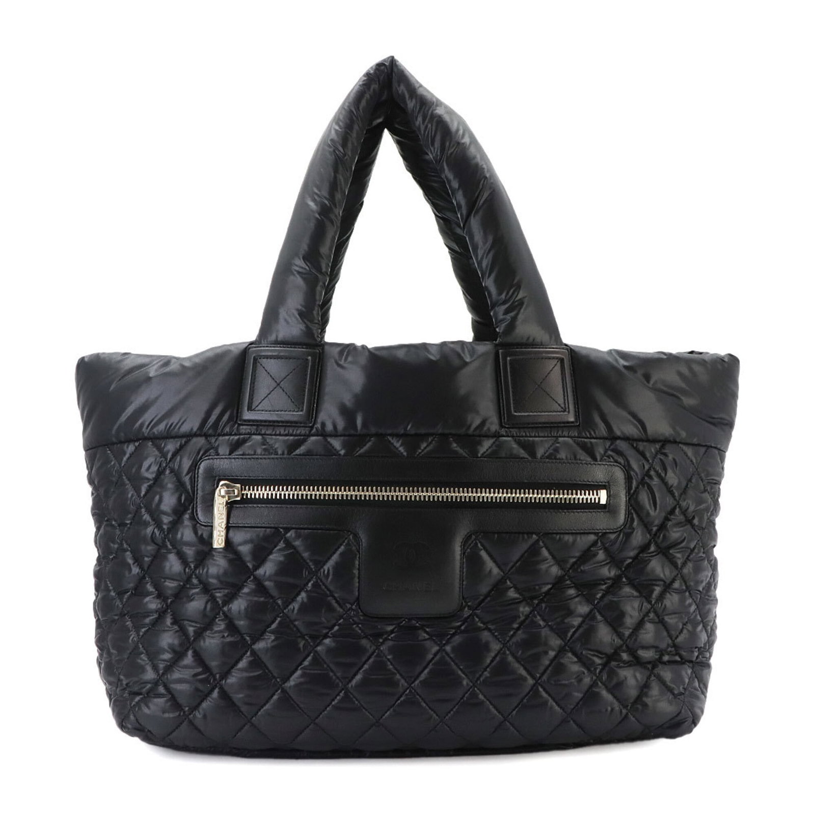 Nylon Leather Tote Chanel Bag Handbag: Nylon Leather Tote Chanel Bag Handbag Nylon Leather Tote Bag with Classic Chanel Style. This black tote bag features a striking combination of nylon and leather materials, with a zipper pocket on the 