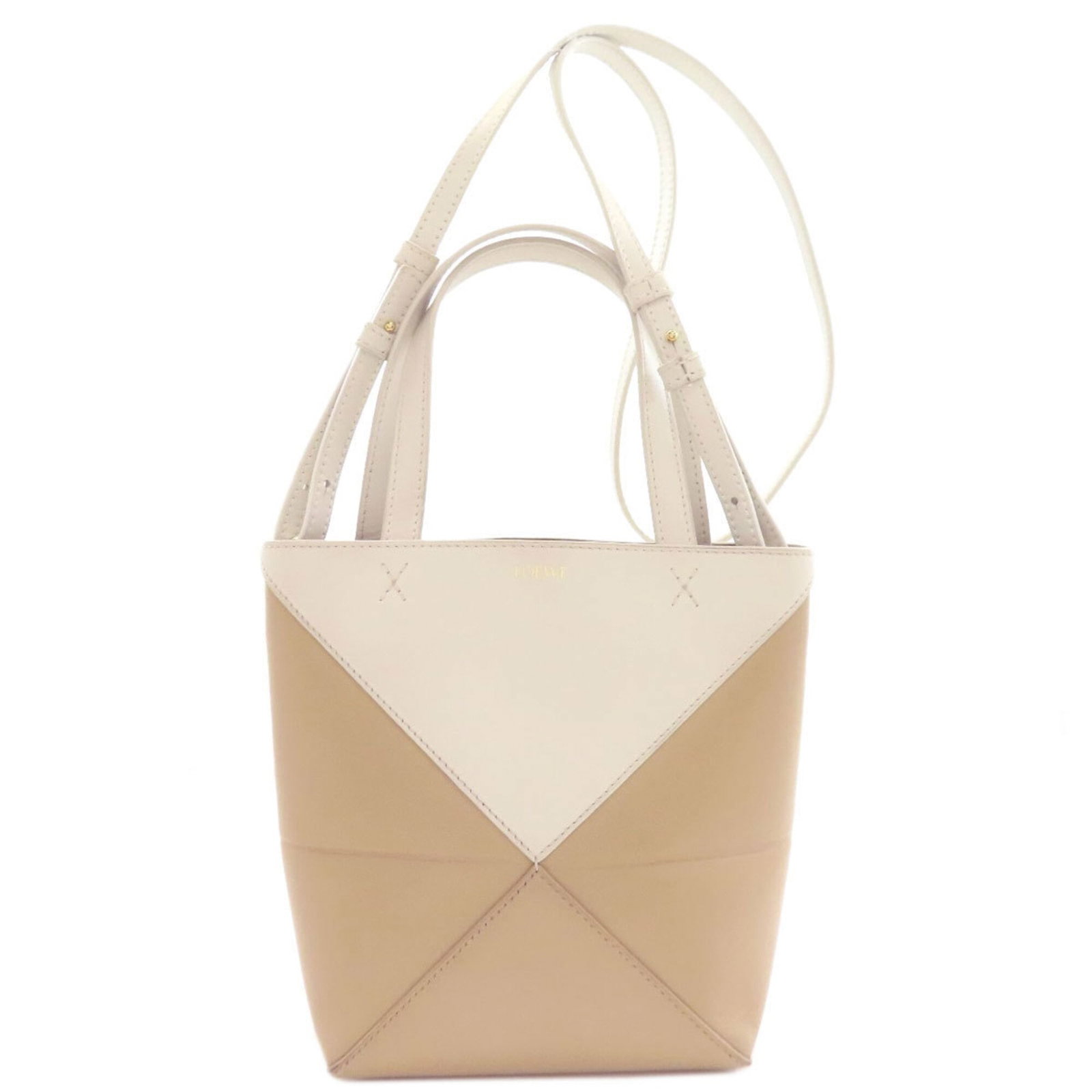 Handbag Leather Handbag: Handbag Leather Handbag The handbag boasts a classic design with a timeless beige and white color combination. Made from high-quality leather, its structured shape and elegant lines make it a stylish