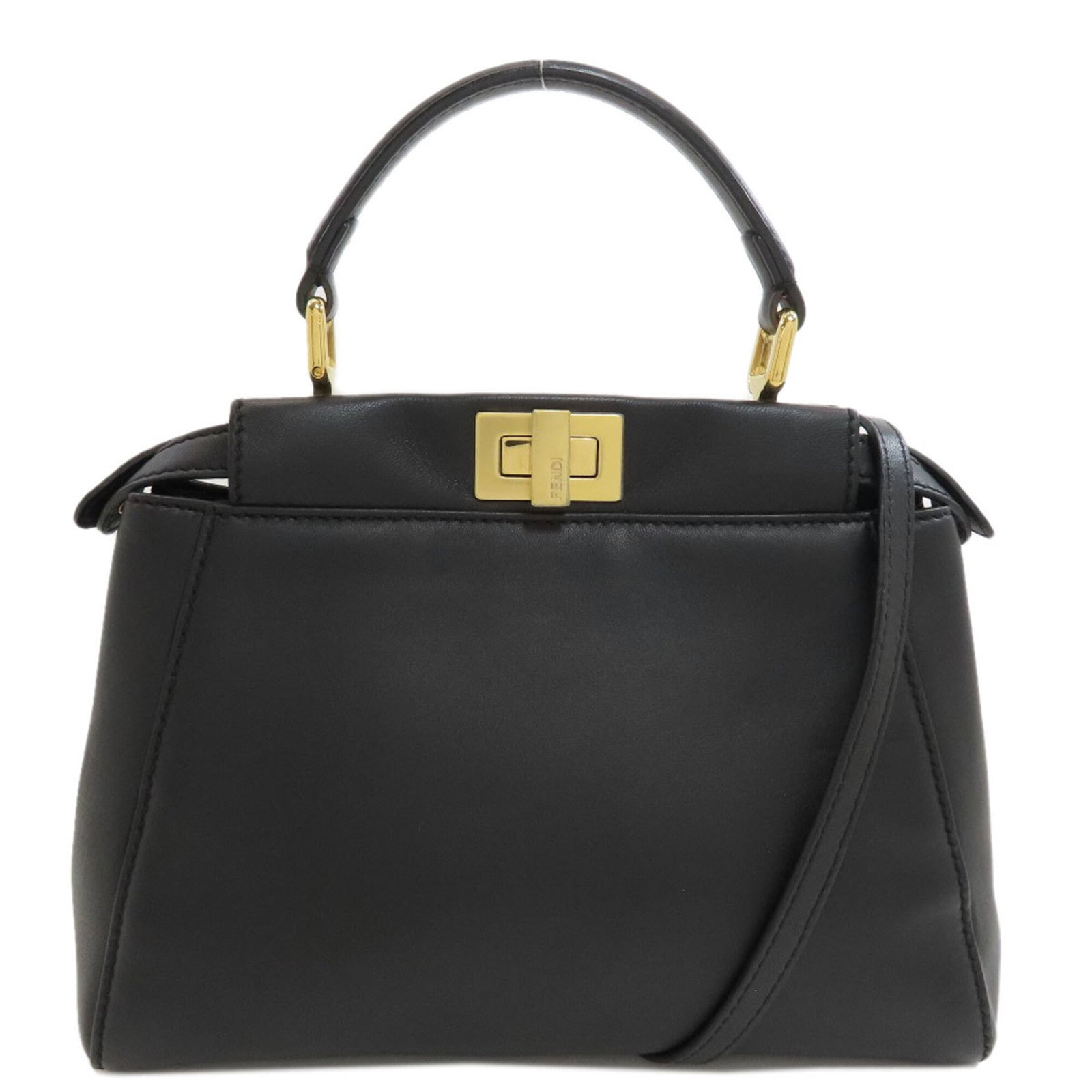 Handbag Leather Fendi: Handbag Leather Fendi Black Fendi Peekaboo Handbag made from high-quality Calfskin leather, featuring a sleek turn lock closure and adjustable strap length. Measuring 17.5cm x 23cm x 10cm, this stylis