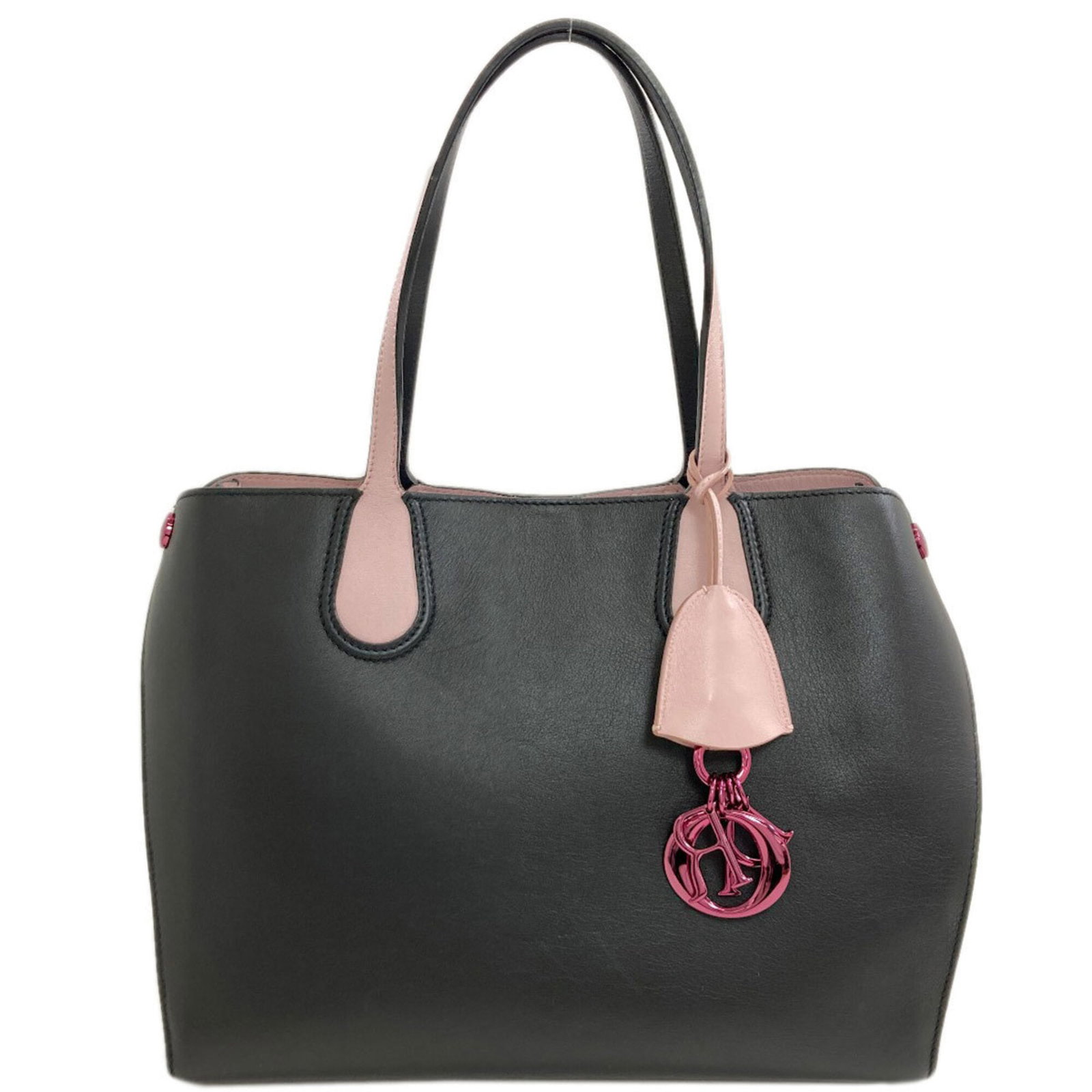 Dior Tote Bag Leather: Dior Tote Bag Leather The Dior Tote Bag Leather is a sleek and sophisticated accessory, crafted from high-quality calfskin leather in a classic black and pink color combination. Measuring 24cm x