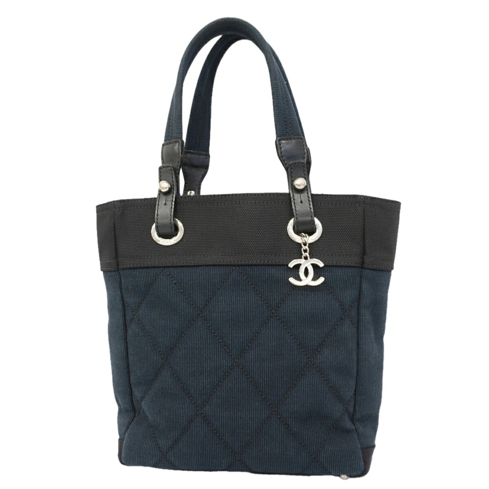Canvas tote bag by Chanel: Canvas tote bag by Chanel Canvas tote bag by Chanel features a sleek black or navy canvas design with silver hardware, making it a stylish and versatile accessory. Measuring 27.5cm x 25cm x 10cm,