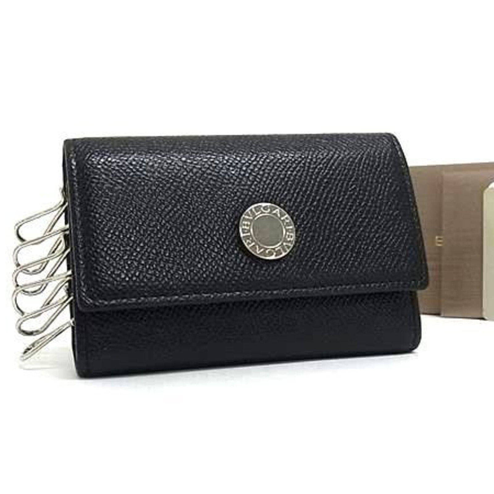 Keycase: Keycase Black Bvlgari Keycase, 6.5cm x 10.5cm x 2cm, bears a signature. Made in Italy, this sleek keycase is a stylish accessory for daily use. Its compact size and durable design make it a practical