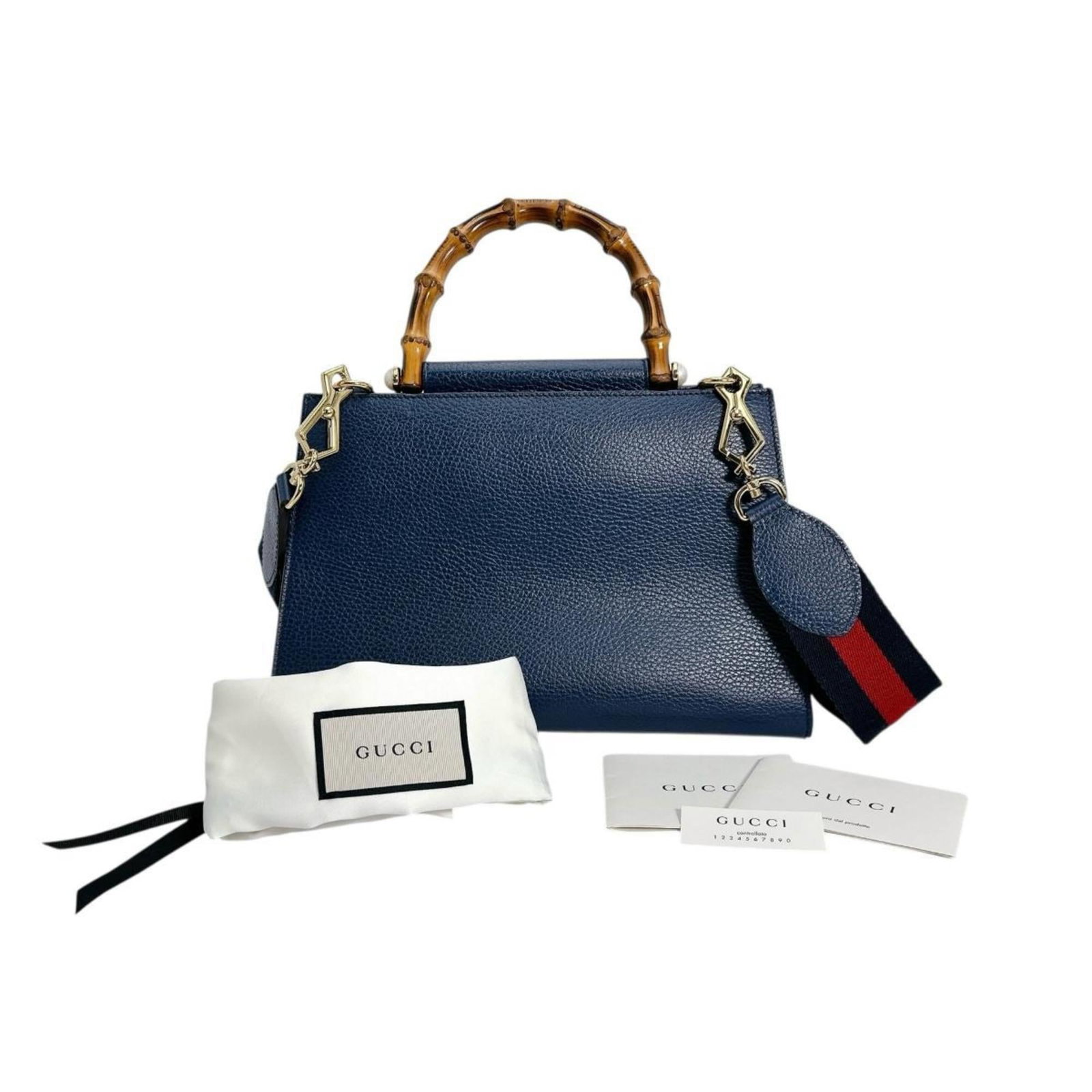 Bamboo Leather Handbag Gucci: Bamboo Leather Handbag Gucci Bamboo and leather come together in this unique Gucci handbag, featuring a striking blue color. The bag's compact size and lightweight design make it a stylish and
