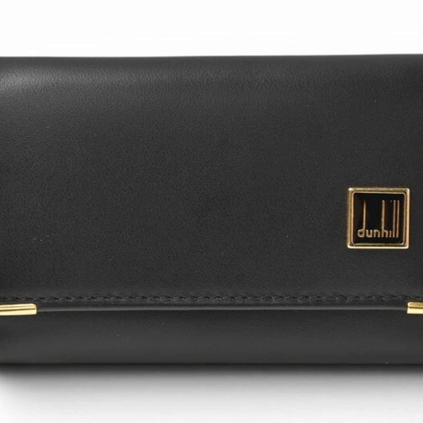Keycase Leather by Dunhill: Keycase Leather by Dunhill Keycase Leather by Dunhill is a sleek, black leather keycase with six key hooks, measuring 6.2cm x 9.5cm x 1.8cm. Made from high-quality leather, this compact case is design
