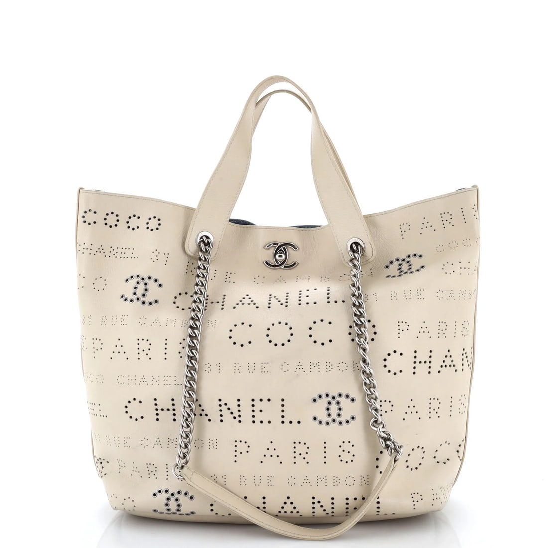 Calfskin Perforated Calfskin Medium Eyelets Shopping Tote Chanel: Calfskin Perforated Calfskin Medium Eyelets Shopping Tote Chanel Calfskin Perforated Calfskin Medium Eyelets Shopping Tote Chanel features a neutral exterior with heavy cracking on corners and