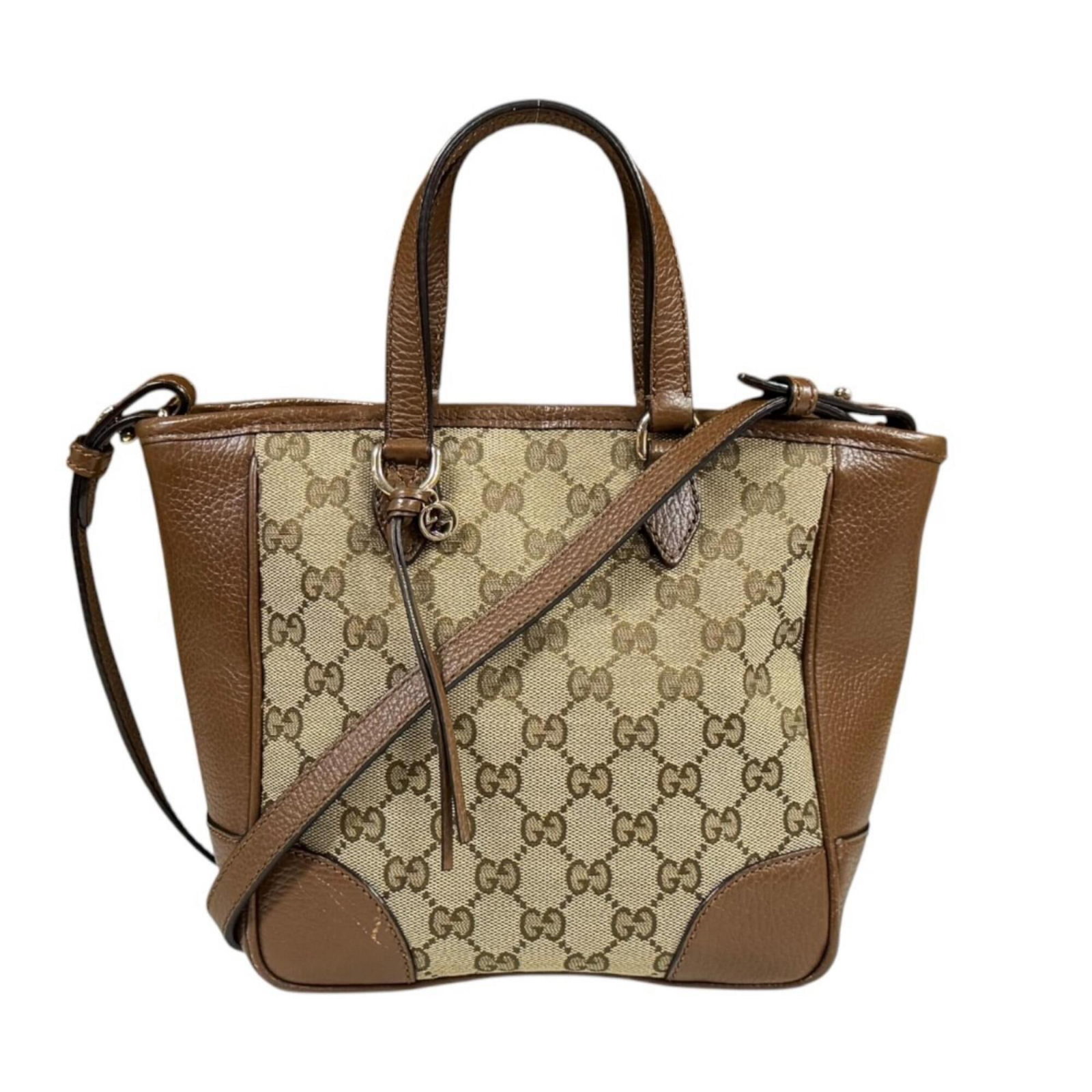 Gucci Handbag Shoulder Bag Gg Canvas: Gucci Handbag Shoulder Bag Gg Canvas Gucci's iconic GG Canvas shoulder bag boasts a timeless beige brown color and sturdy zipper closure, making it a versatile accessory for everyday use. Crafted from