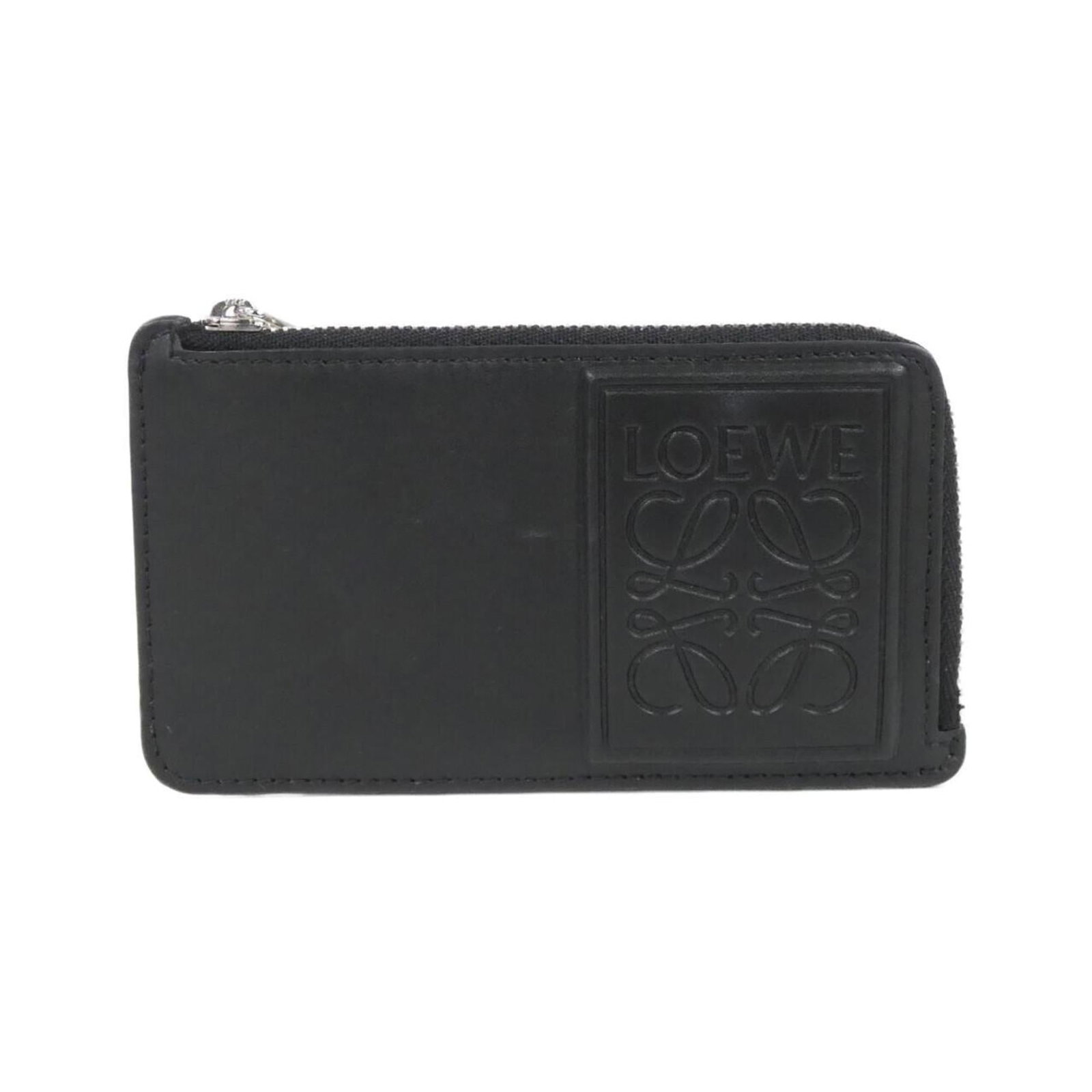 Loewe Coin Purse/ Coin Case Leather: Loewe Coin Purse/ Coin Case Leather The Loewe Coin Purse/ Coin Case Leather is a sleek and sophisticated accessory made from high-quality calfskin leather. Its compact size and classic design make it