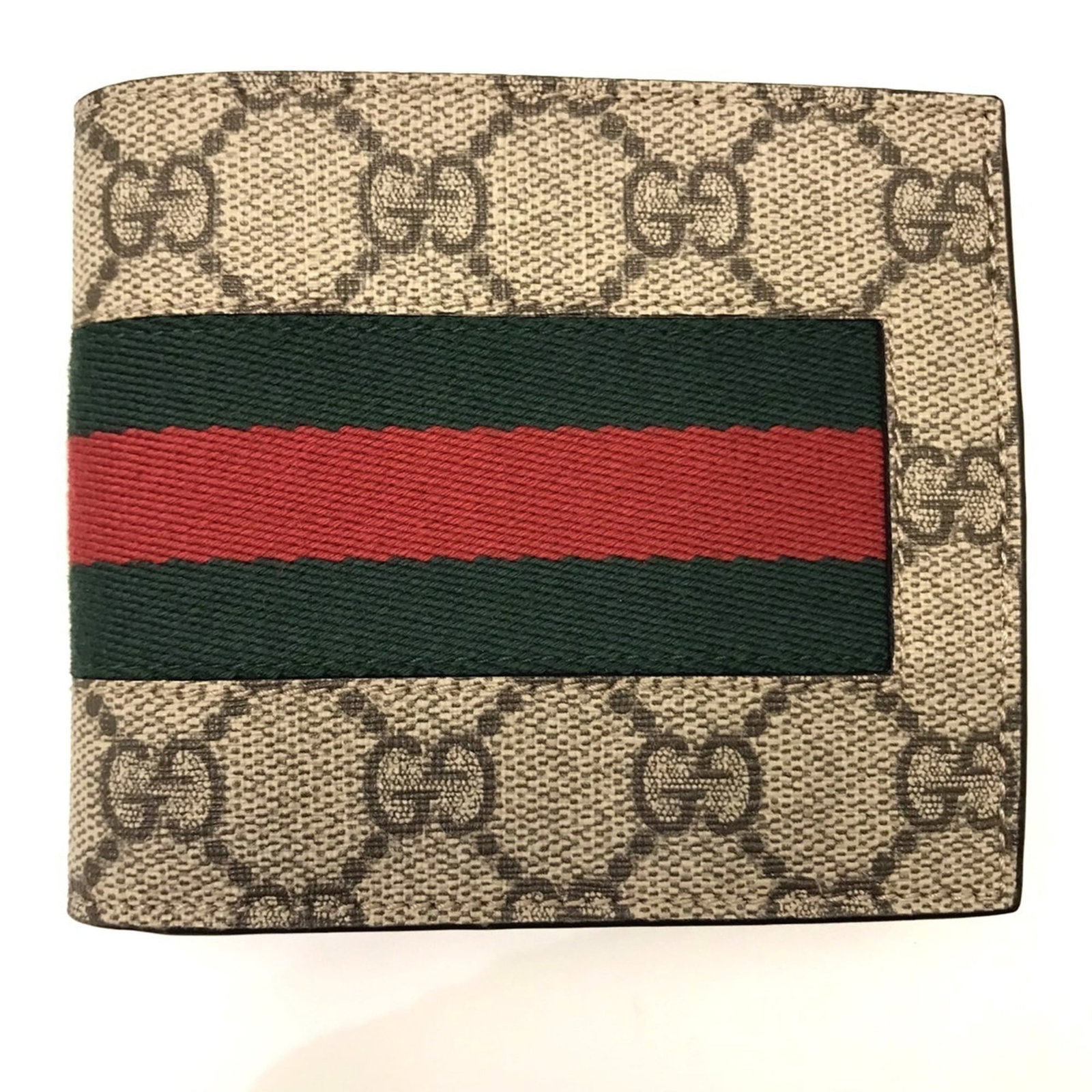 Gucci Supreme Leather Bi Fold Wallet: Gucci Supreme Leather Bi Fold Wallet Gucci Supreme Leather Bi Fold Wallet, marked with a serial number on the body, boasts a classic bi-fold design with a signature GG Supreme logo. The wallet