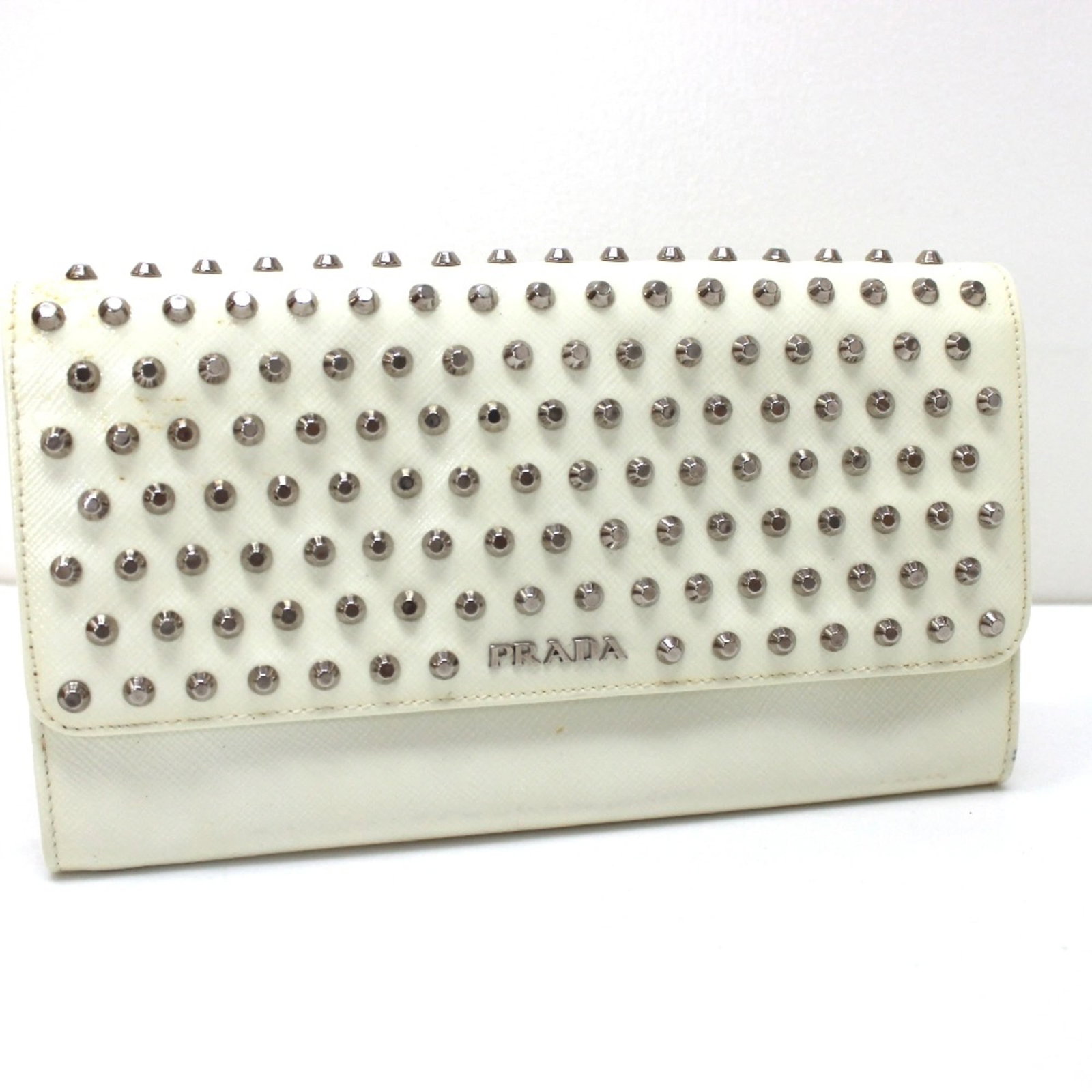Prada Long Wallet (Bi-Fold) Leather: Prada Long Wallet (Bi-Fold) Leather White Prada Long Wallet (Bi-Fold) Leather, measuring 21cm x 11.5cm (8.3" x 4.5") in size, is a classic bi-fold design made from high-quality leather. This stylish