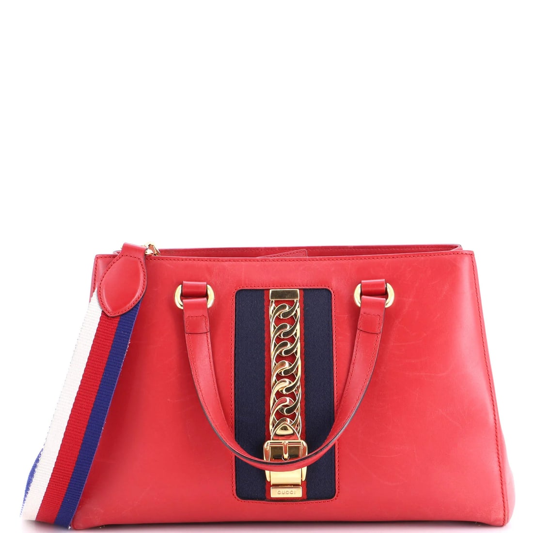 Large Leather Tote Sylvie Top Gucci: Large Leather Tote Sylvie Top Gucci Large Leather Tote Sylvie Top Gucci in Red, featuring a classic satchel style with a gold-tone handle and microfiber interior. The exterior shows signs of wear,