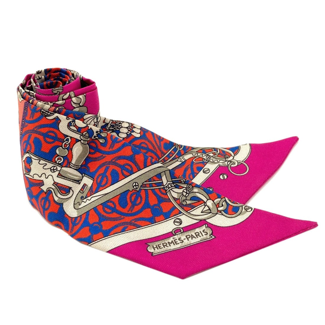Hermes Silk Twilly Scarf: Hermes Silk Twilly Scarf Pink silk twilly scarf from HERMES, featuring a vibrant exterior color. Made from high-quality silk, this scarf is a stylish accessory. The signature is present. Item