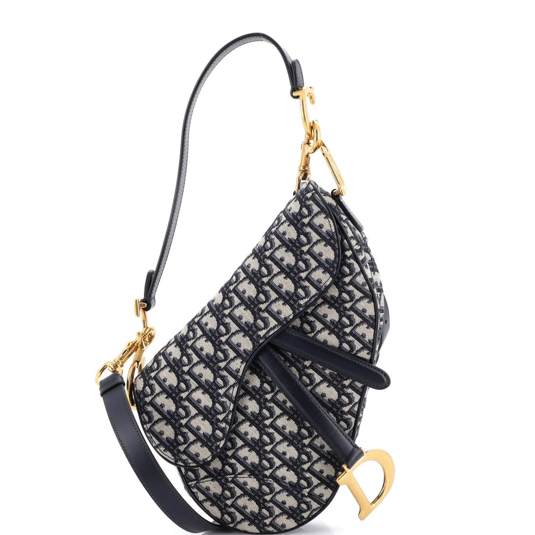Saddle Handbag Strap Oblique Canvas Medium Christian Dior: Saddle Handbag Strap Oblique Canvas Medium Christian Dior Saddle Handbag with Strap Oblique Canvas Medium from Christian Dior features a striking blue canvas exterior with oblique design, showcasing