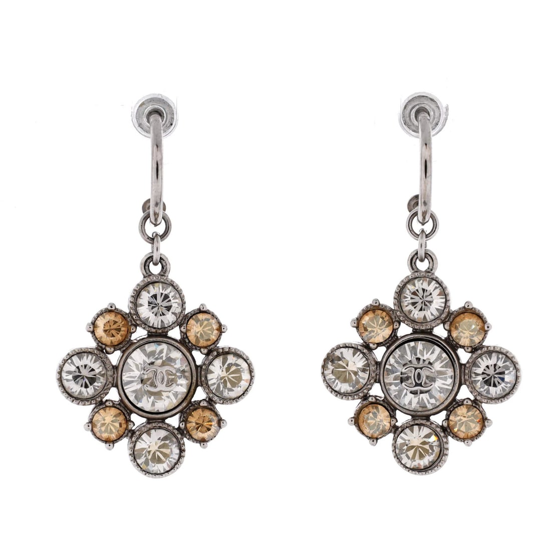 Metal CC Chanel Floral Earrings with Crystals Drop: Metal CC Chanel Floral Earrings with Crystals Drop Dangle/drop earrings with a silver metal exterior, adorned with crystals, and featuring the iconic CC floral design from Chanel. The earrings have a