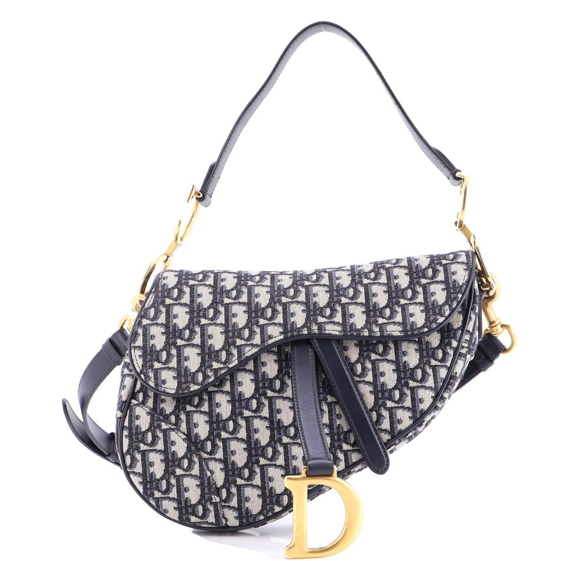 Saddle Handbag Strap Oblique Canvas Medium Christian Dior: Saddle Handbag Strap Oblique Canvas Medium Christian Dior Saddle Handbag with Strap Oblique Canvas Medium in Blue. This Christian Dior shoulder bag features a striking oblique canvas design and a