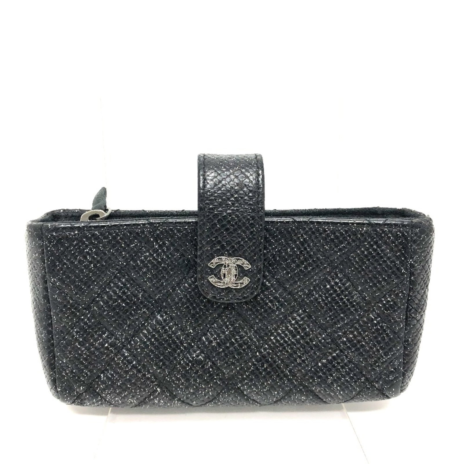 Leather Pouch by Chanel: Leather Pouch by Chanel Black leather pouch by Chanel, measuring 13cm x 7cm x 3cm, features a sleek design and signature. This stylish accessory is made from high-quality leather and bears a serial