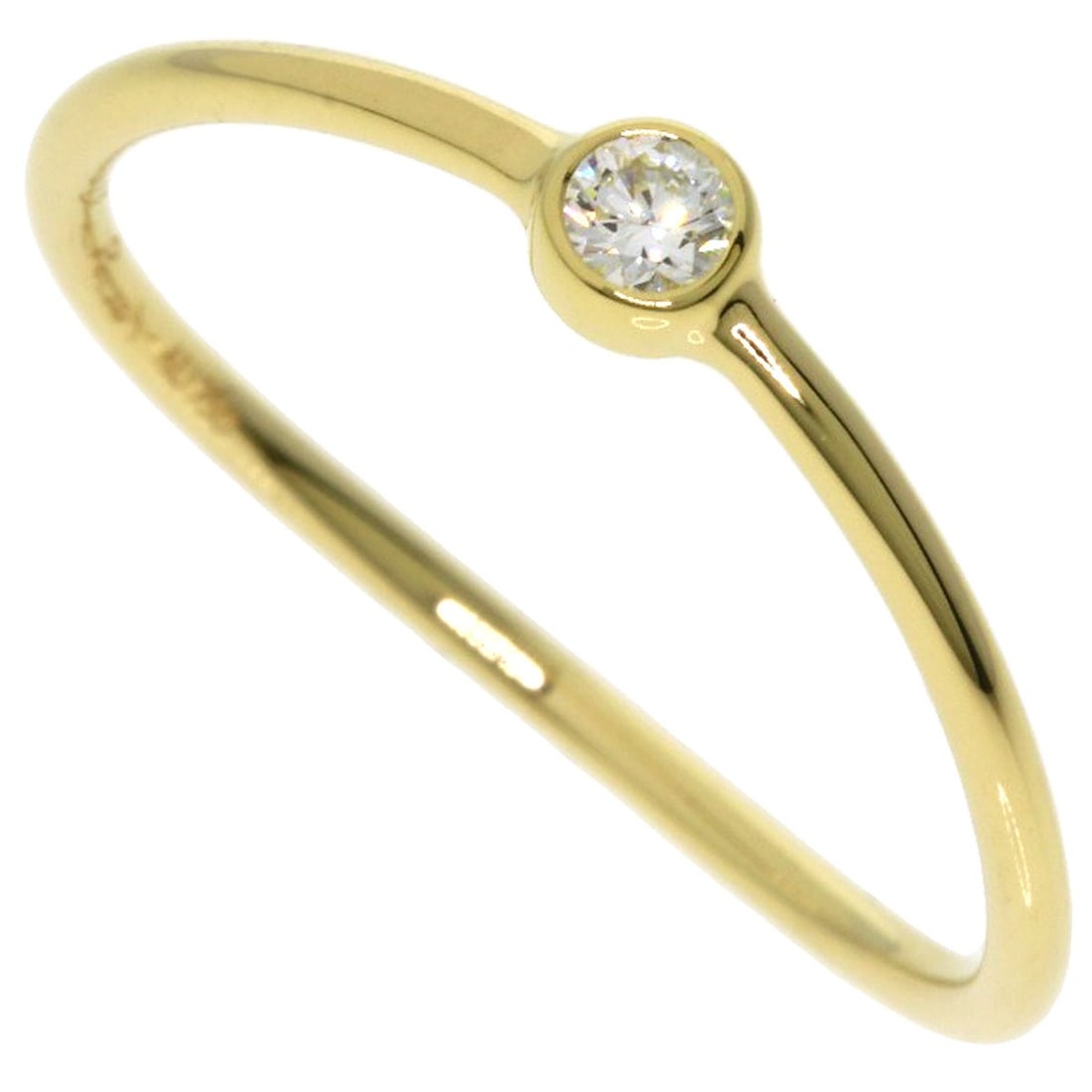 Single Wave Diamond Ring Tiffany&Co. K18 Yellow Gold: Single Wave Diamond Ring Tiffany&Co. K18 Yellow Gold Single Wave Diamond Ring in K18 Yellow Gold. This Tiffany&Co. ring showcases a single diamond set in K18 yellow gold, a high-purity gold alloy.