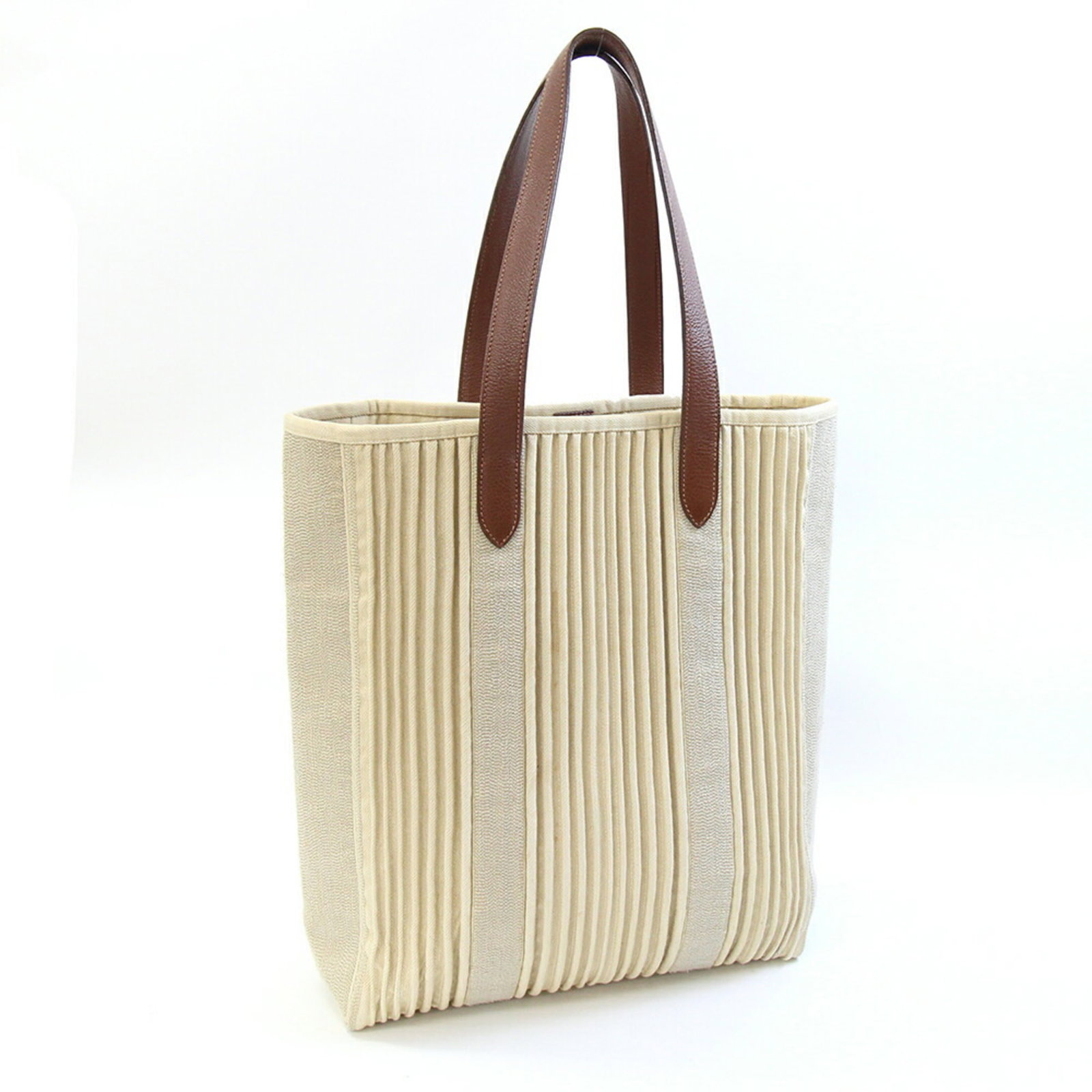 Canvas tote bag Hermes: Canvas tote bag Hermes Canvas tote bag from Hermes, made from high-quality canvas material, features a classic beige and brown color combination. The bag measures 38cm x 30cm x 11.5cm, making it a