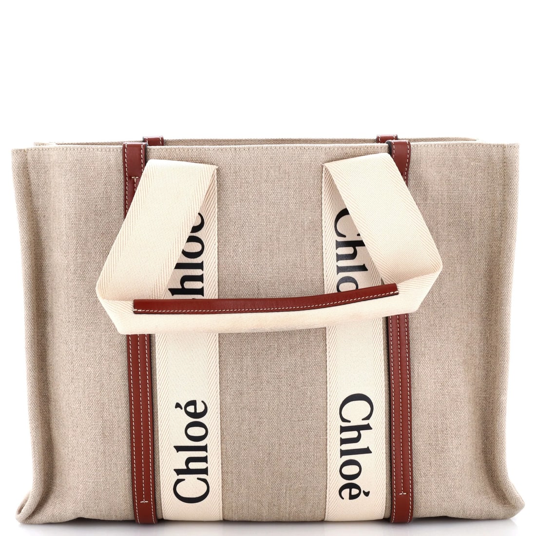 Large Canvas Tote with Leather Chloe: Large Canvas Tote with Leather Chloe Brown canvas tote with a classic leather Chloe design, featuring a large size and sturdy construction. The tote boasts a timeless style with a brown interior and